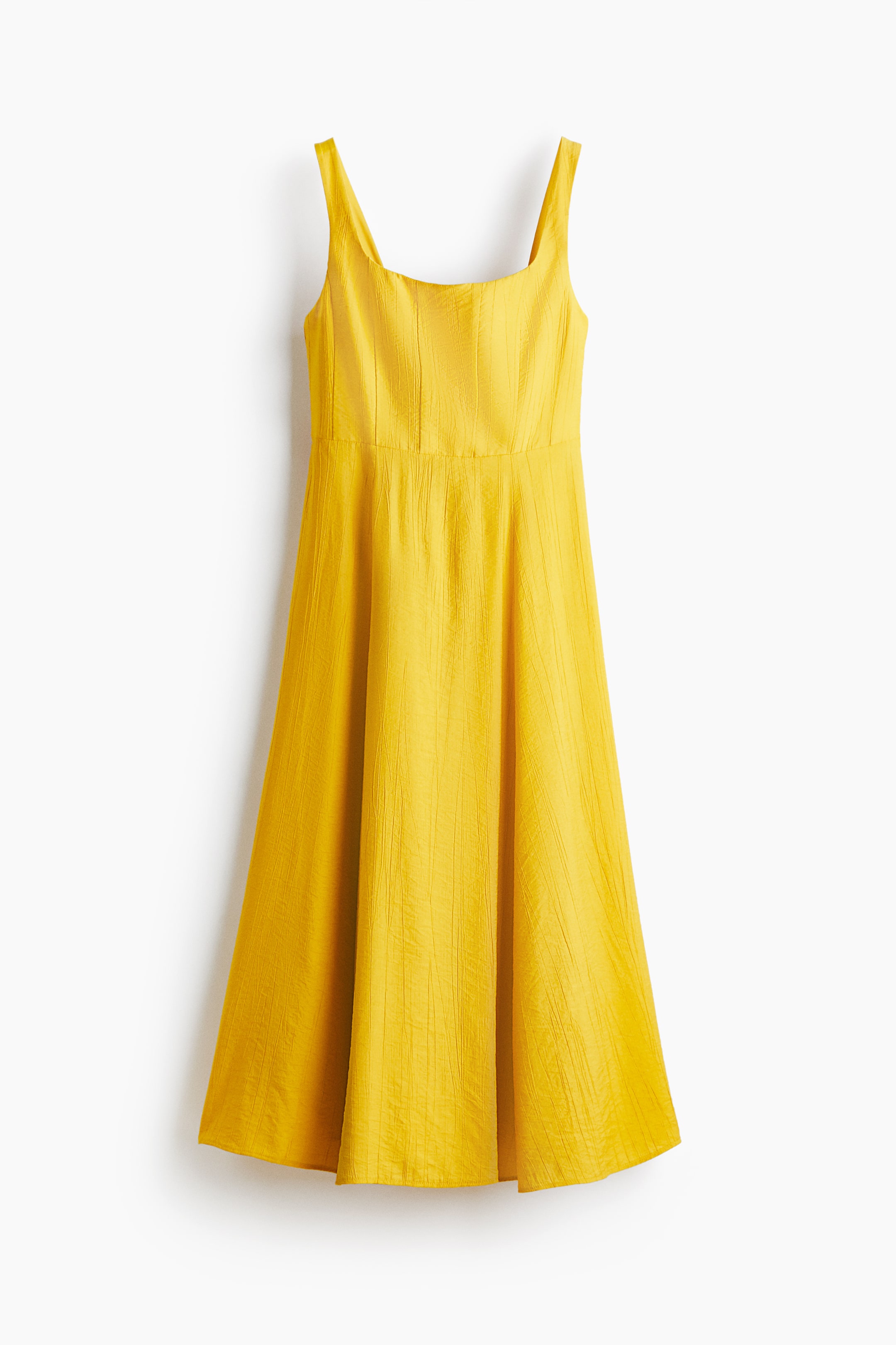 View larger image: The yellow dress showcases a square neckline with wide straps, complemented by a fitted bodice at the front and a flowing A-line skirt, crafted from crinkled fabric.