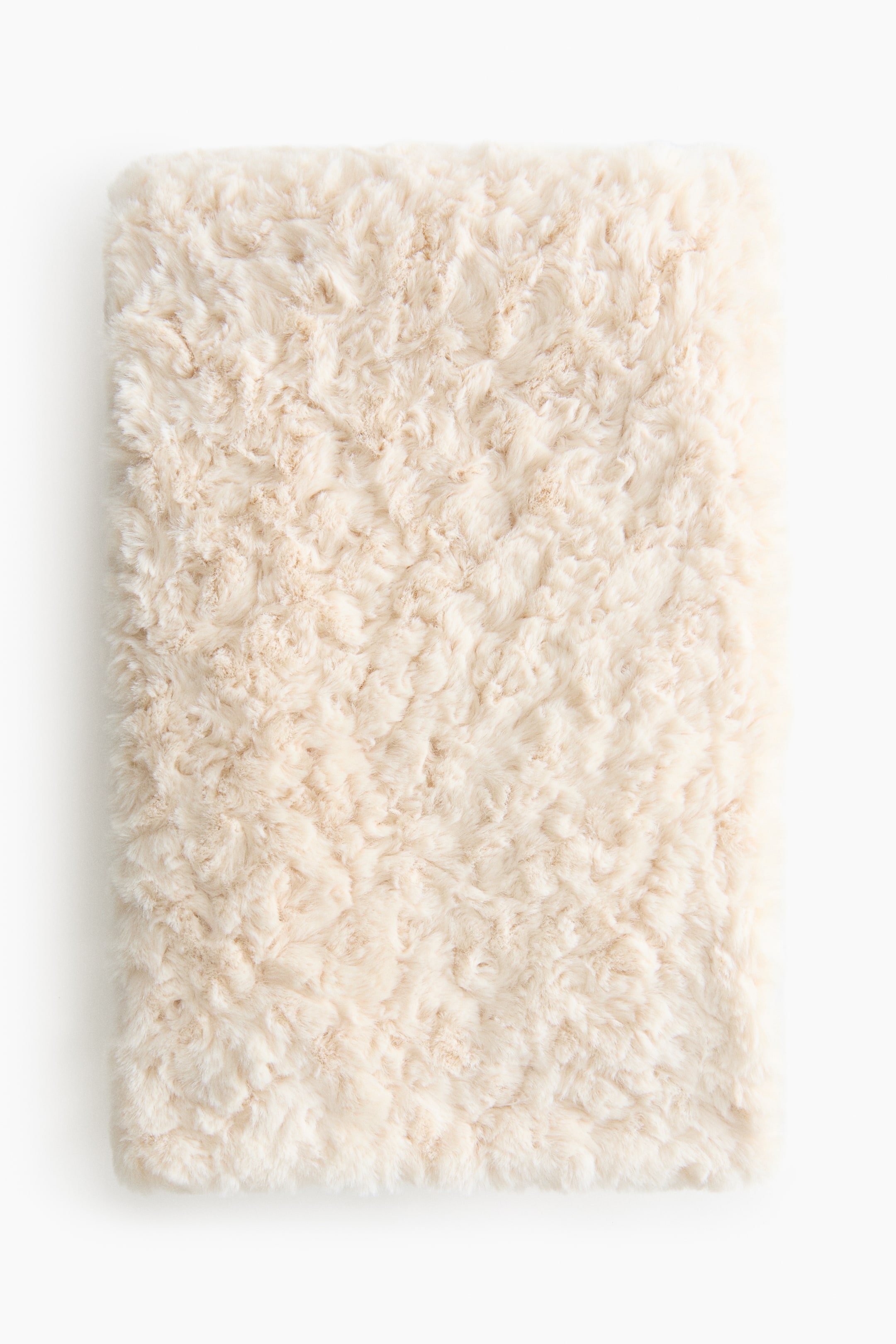View larger image: An off-white rectangular product is covered in fluffy, textured faux fur. Its surface features a soft, swirling pattern.