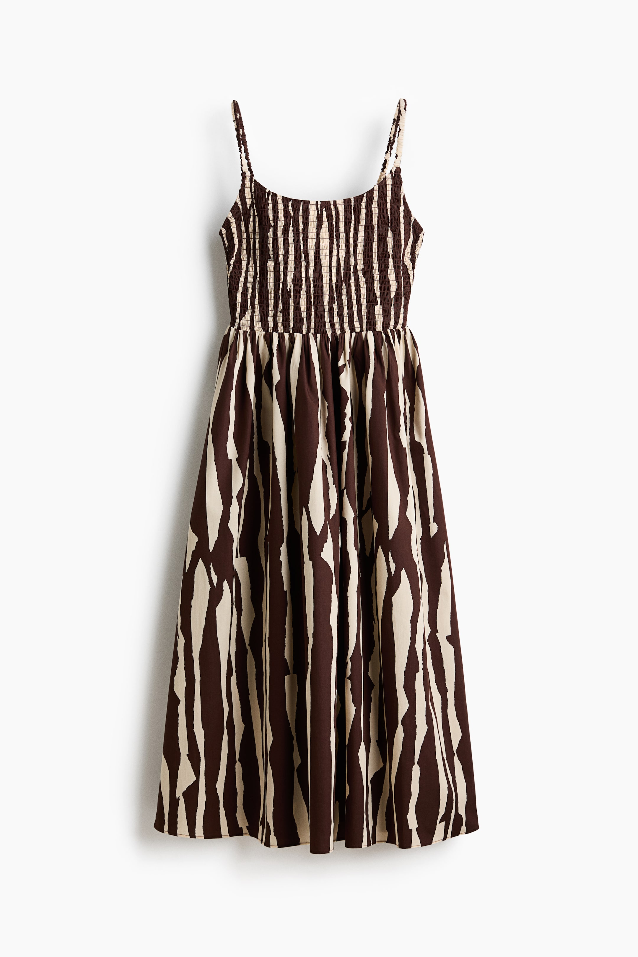 View larger image: A dress is presenting as FRONT, featuring a brown and cream abstract vertical stripe pattern. It is designed with thin spaghetti straps, a shirred bodice, and a gathered midi-length skirt.