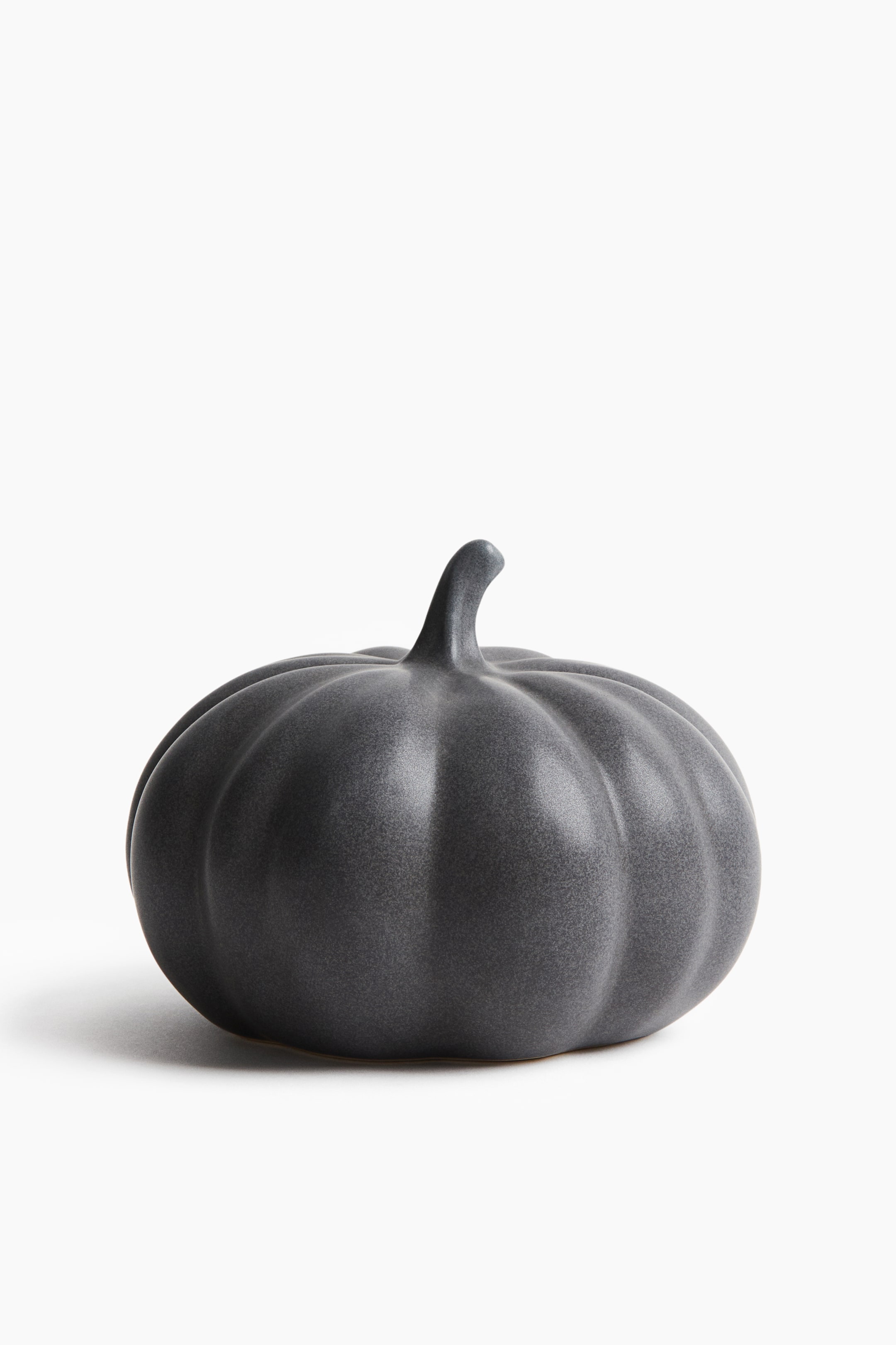 View larger image: A pumpkin-shaped stoneware decoration features a dark gray, speckled surface with distinct vertical ribs and a short, curved stem.