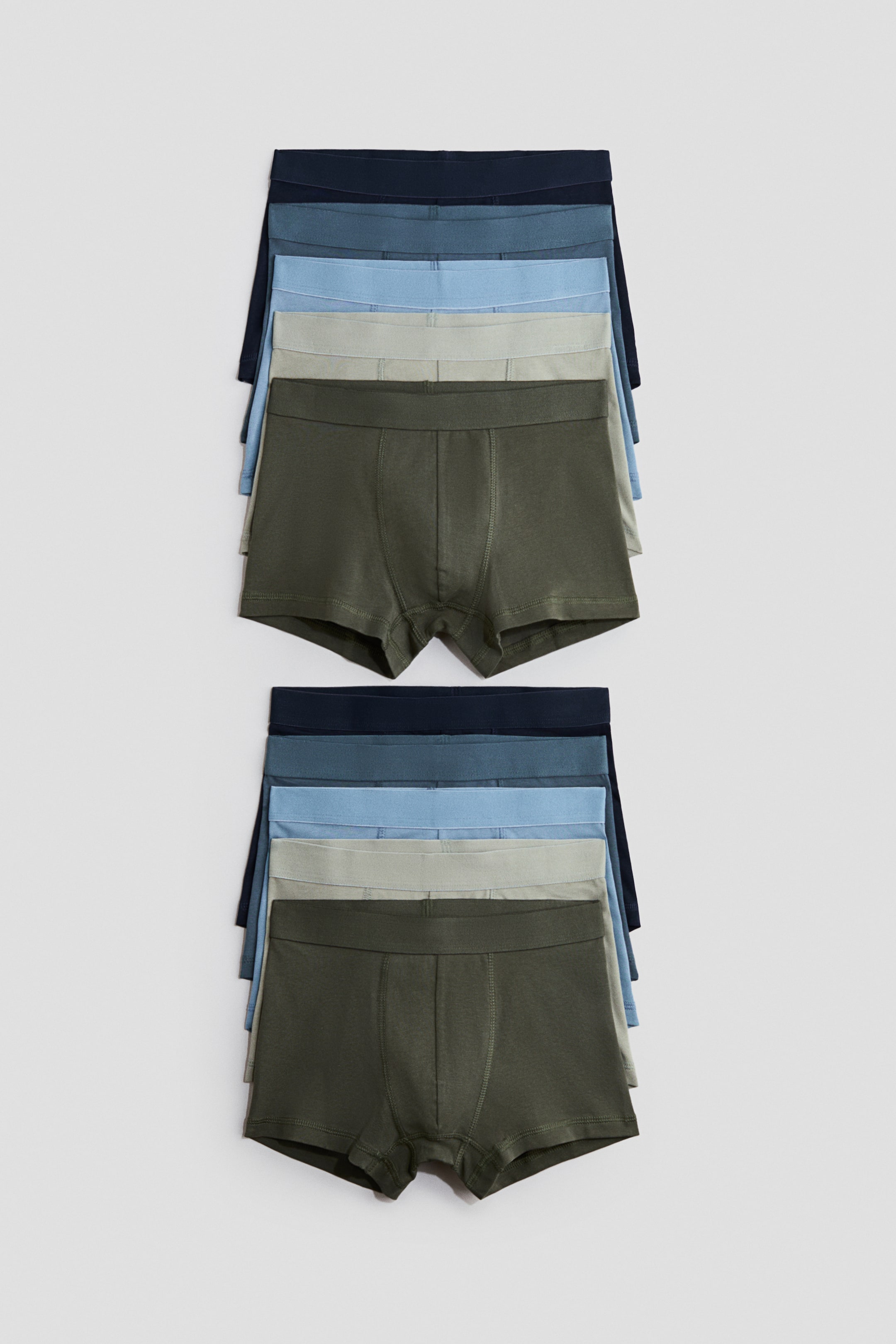 View larger image: "Two sets of five boxer briefs are stacked, showcasing a gradient of colors. The front-facing boxer briefs in each stack are olive green, featuring a solid waistband and visible front pouch stitching. Behind them, waistbands of light sage green, light blue, medium blue, and dark blue boxer briefs are partially visible."