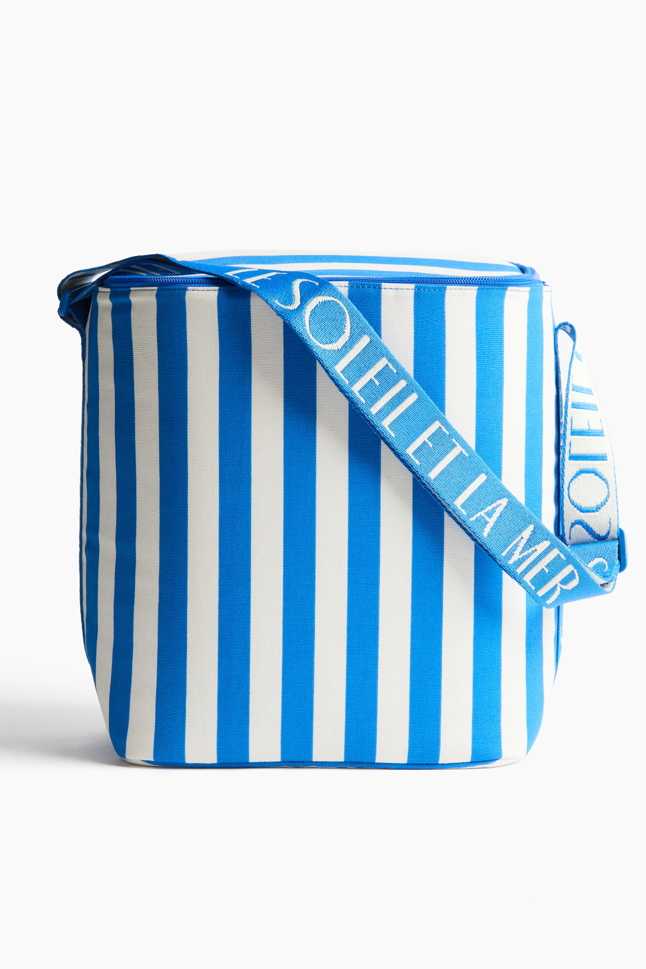 View larger image: A cooler bag, viewed from the FRONT, showcases a blue and white vertical stripe pattern, a blue zipper closure on top, and a blue shoulder strap with "SOLEIL ET LA MER" text in white.