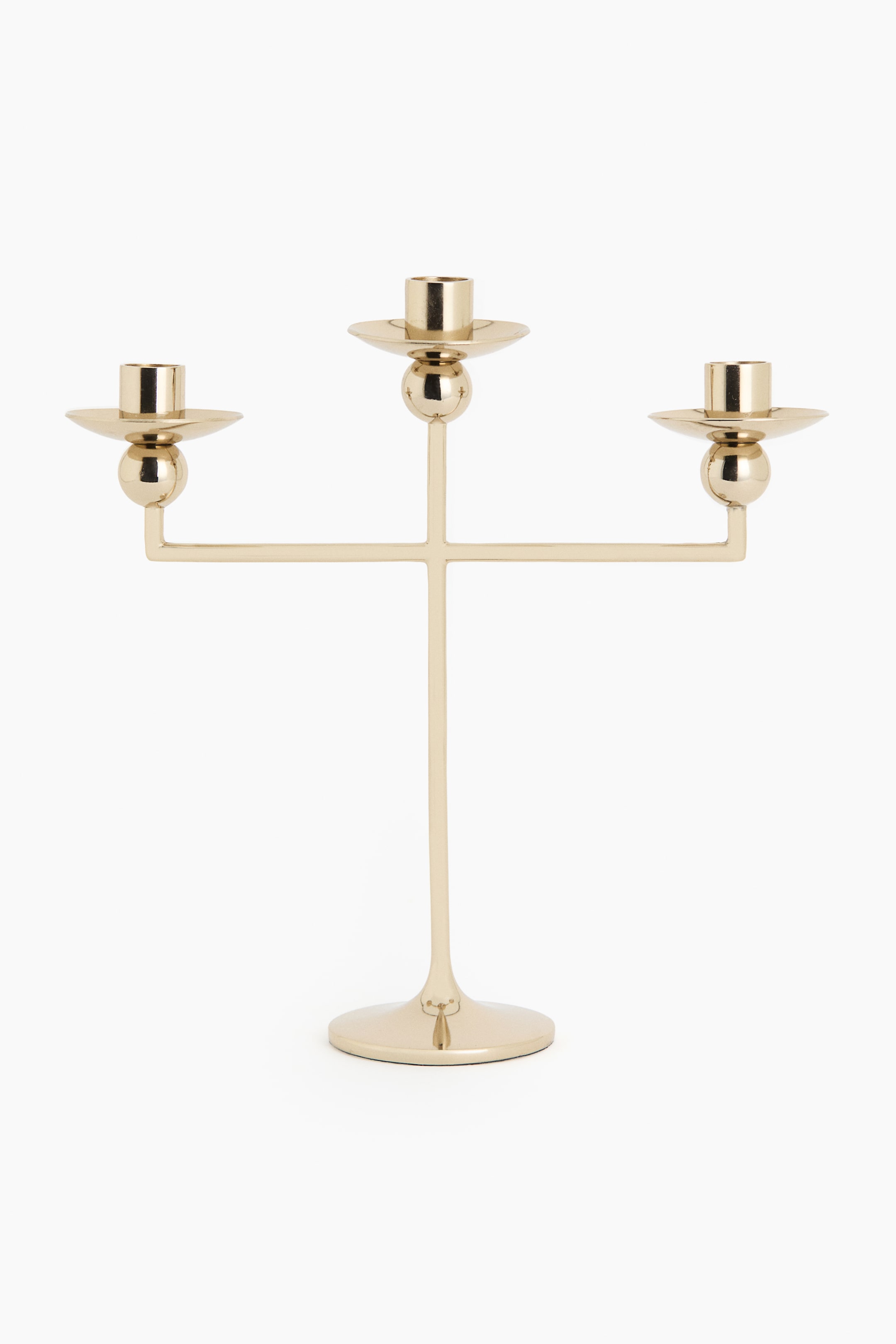 View larger image: A three-armed candelabra is showcasing polished gold-toned stainless steel, featuring a sleek design with three cup-shaped candle holders, each positioned above a spherical detail, branching horizontally from a central stem and resting on a round base, as seen from the front.