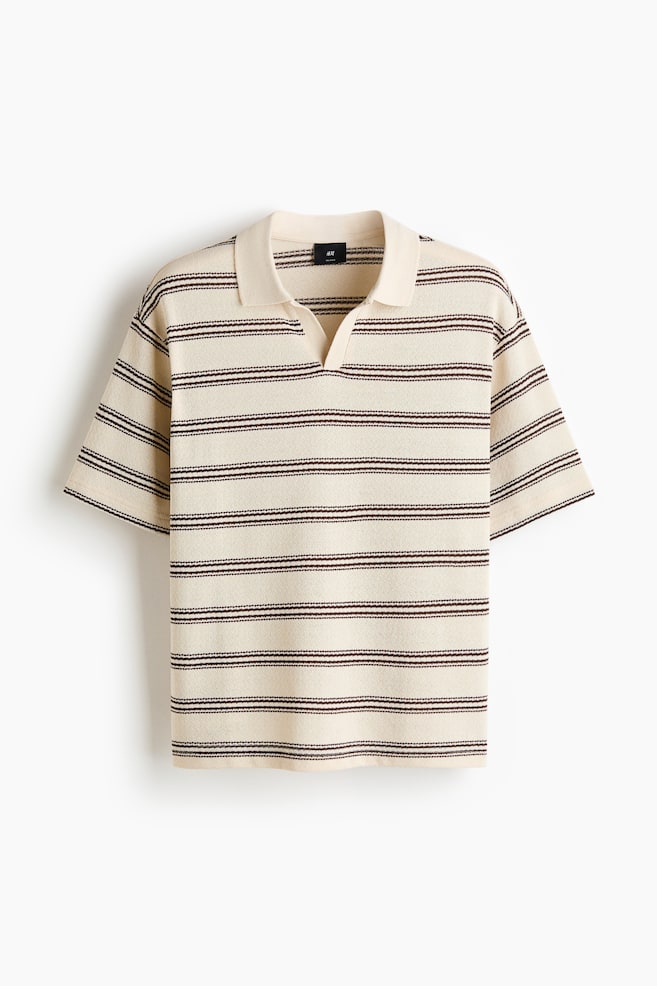 A cream knit polo shirt is shown from a front perspective, featuring multiple dark brown horizontal stripes made up of two thin lines. It is designed with a spread collar and a V-neck opening, and it displays short sleeves. - 1