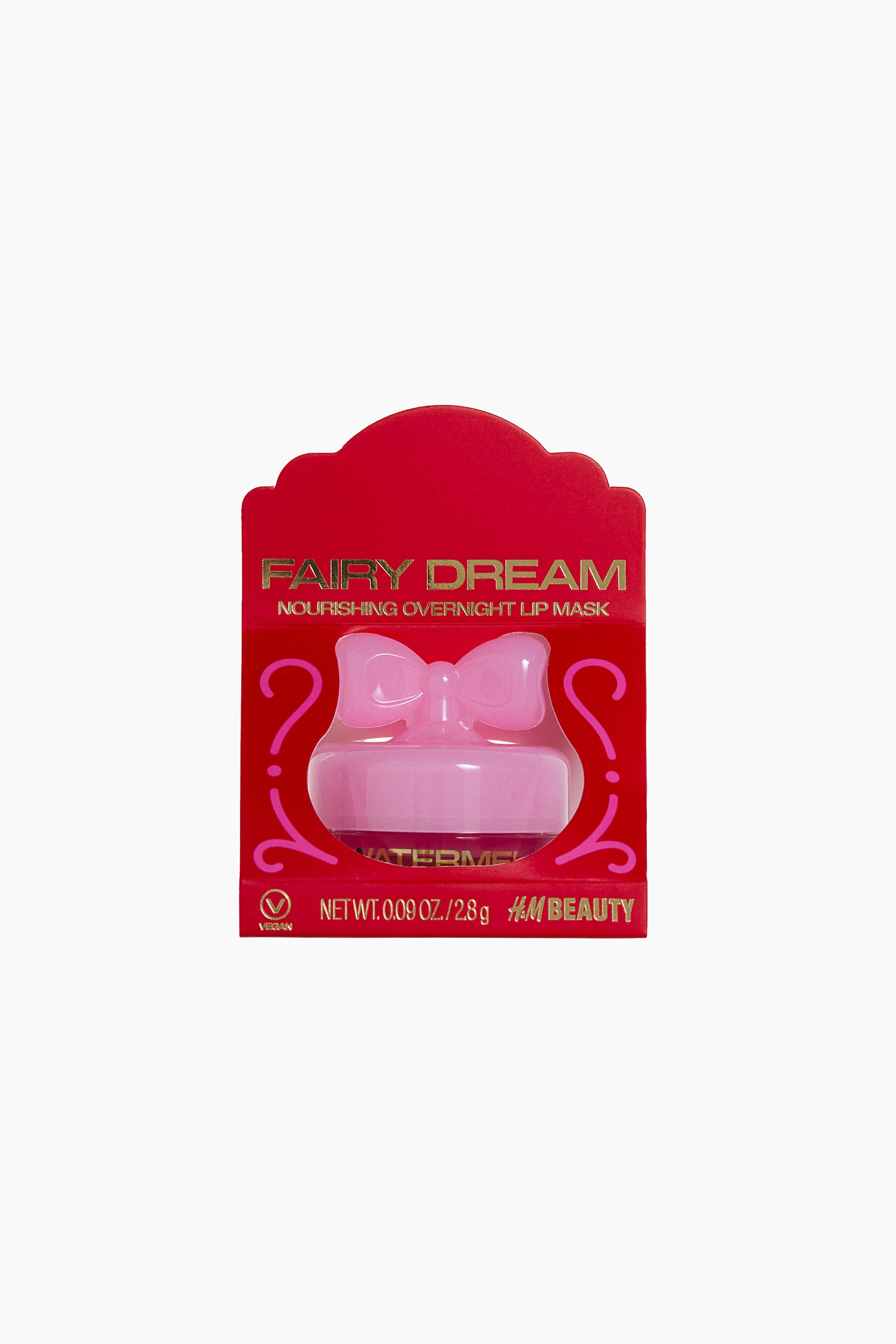 View larger image: A front-facing view shows the Fairy Dream Nourishing Overnight Lip Mask housed in a red cardboard package with gold lettering. The package holds a small jar containing a pink lip mask, topped with a light pink cap shaped like a bow.