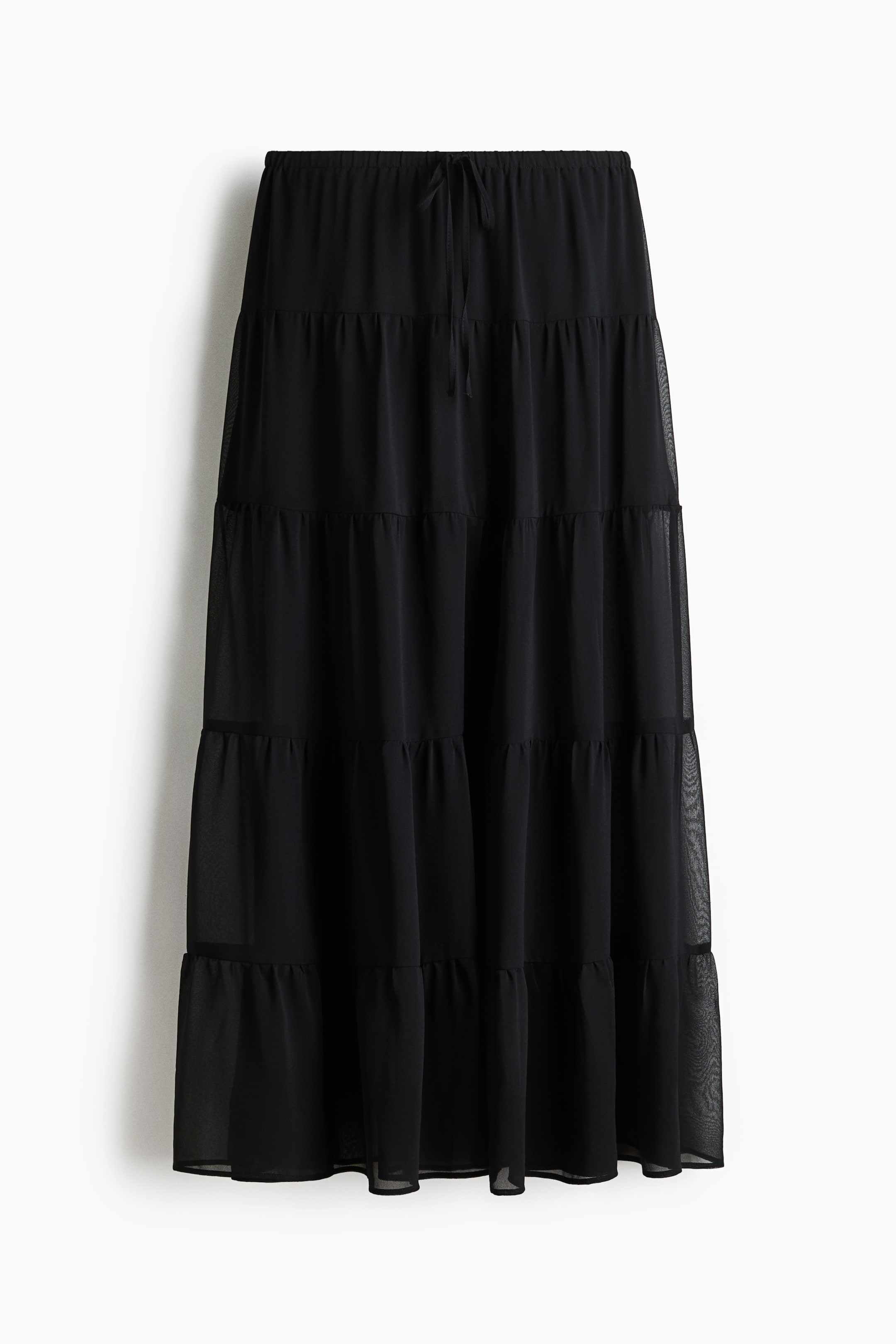 View larger image: A black tiered skirt features an elasticated waistband with a front drawstring. It is constructed from multiple gathered tiers of sheer fabric.
