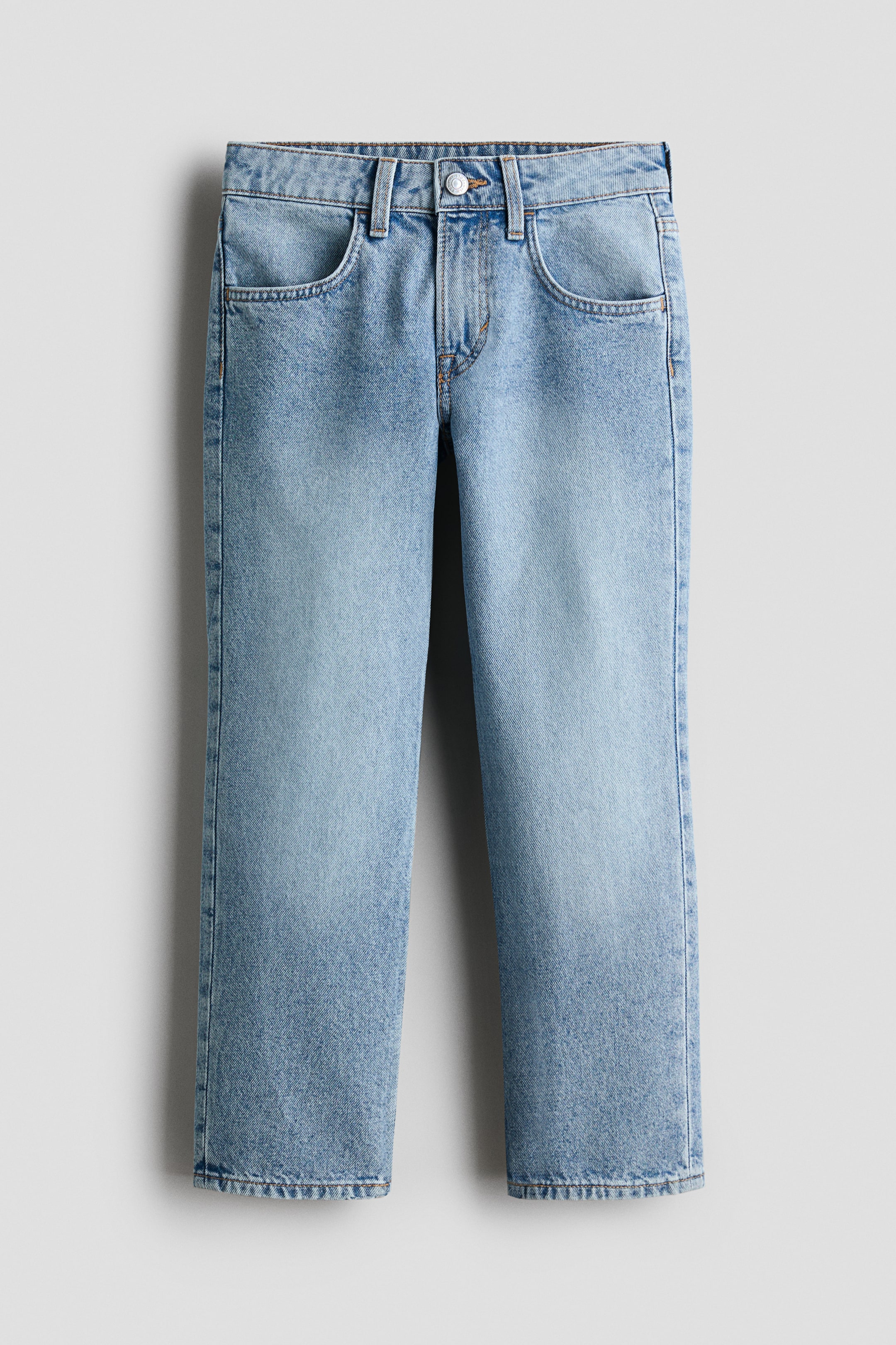 View larger image: Light blue washed cotton denim jeans showcase a front view with a relaxed fit through the hip and thigh, straight legs, a zip fly with a button, and front pockets.