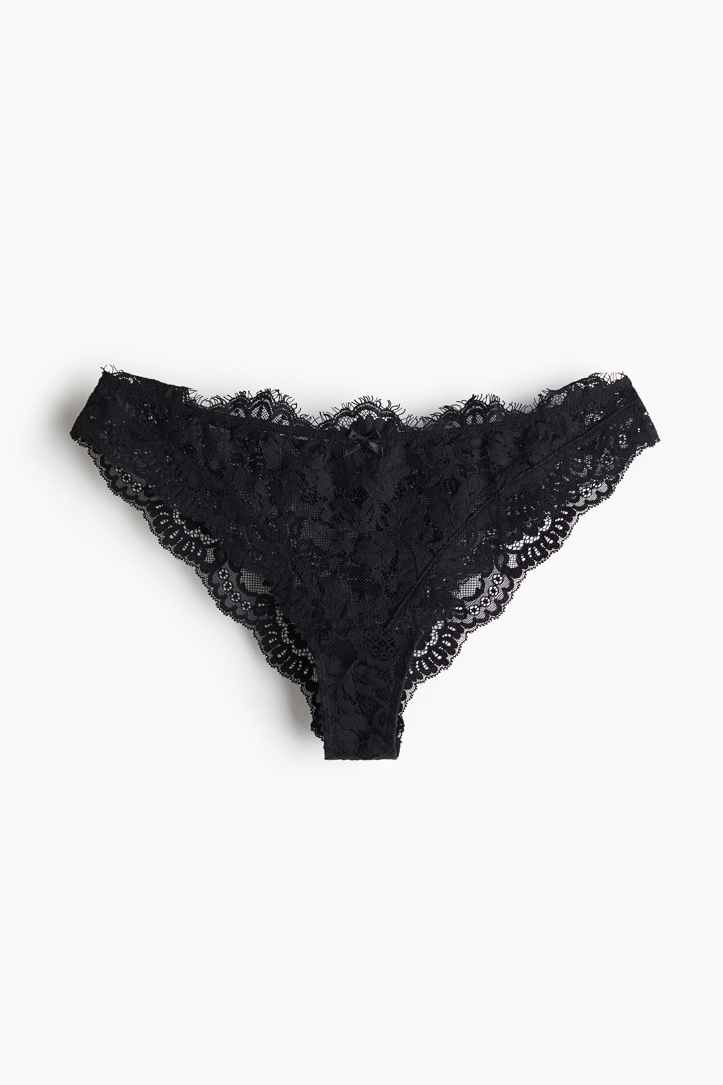 Black lace briefs featuring a low-rise waist and scalloped lace trim are being worn by the model, paired with a matching sleeveless black lace top.