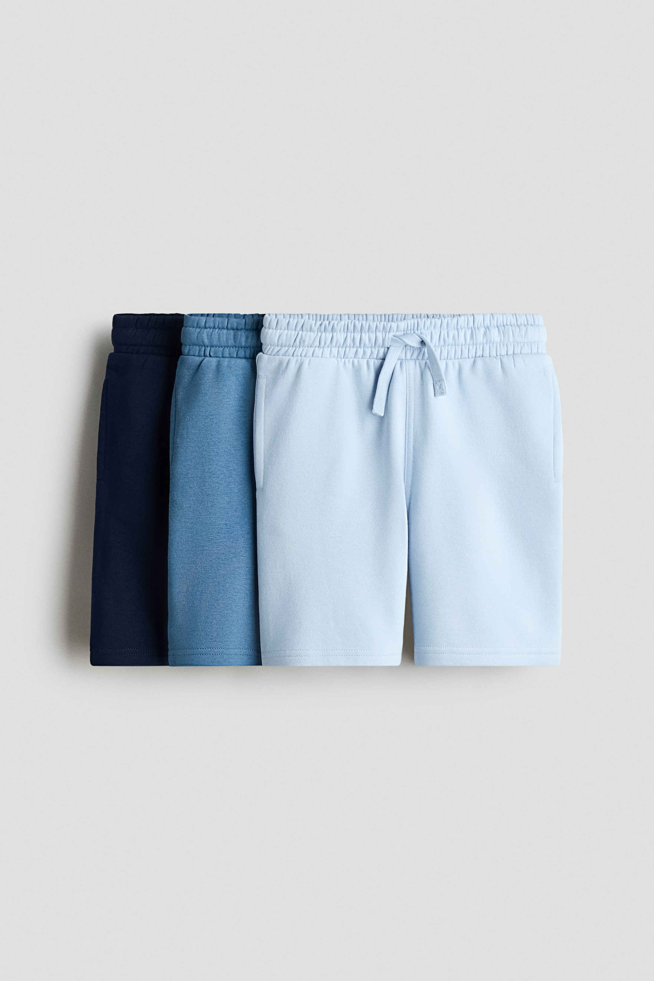 View larger image: Shorts are displaying in a set of three blue hues, from dark to light, with the frontmost pair facing front. 