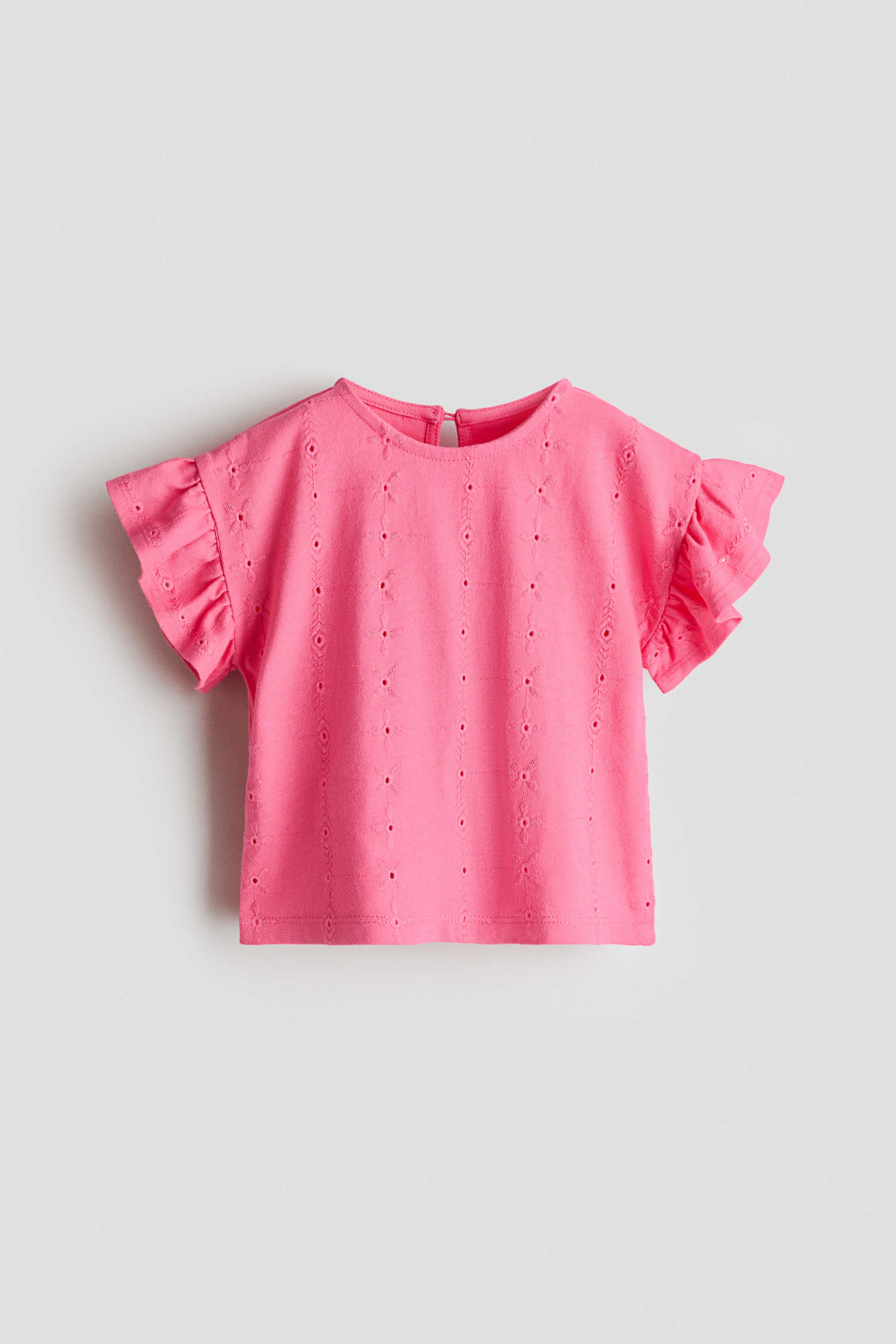 View larger image: The pink top showcases a round neckline and short, ruffled sleeves. It features vertical rows of eyelet embroidery and a keyhole opening with a button closure at the back of the neck.