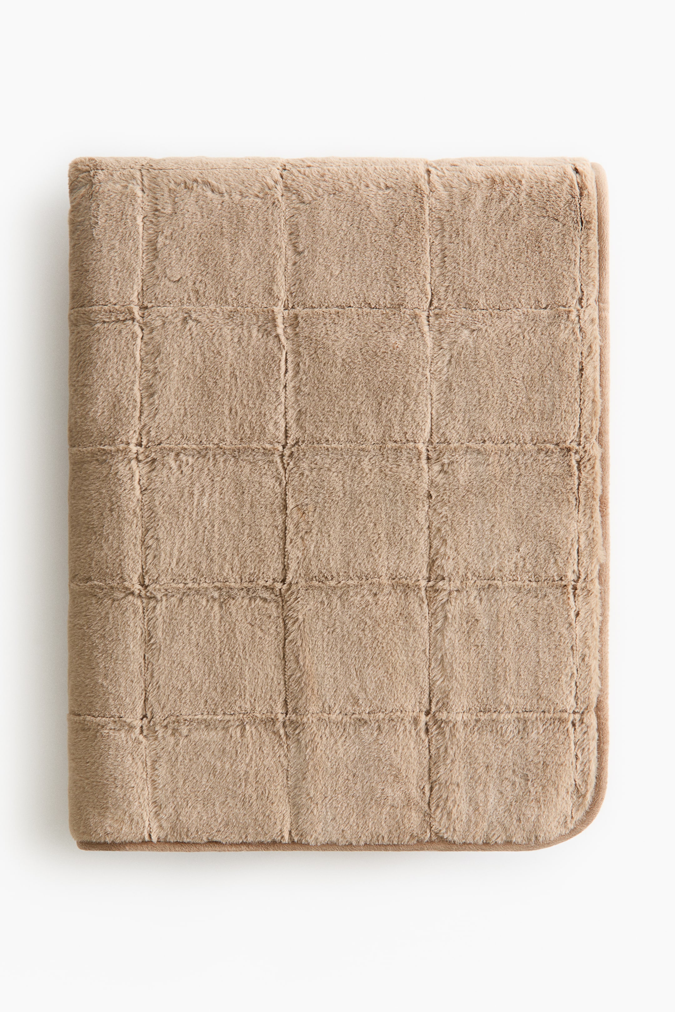 View larger image: A light brown faux fur blanket features a quilted grid pattern, with its folded form lying flat.