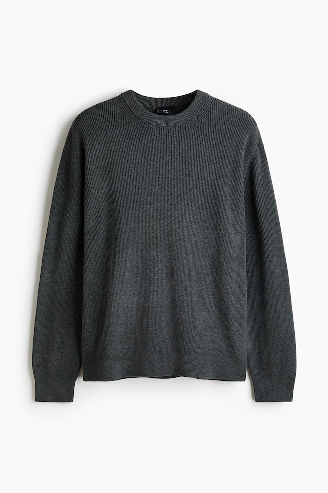 A dark gray ribbed knit sweater is lying flat, facing forward, featuring a crew neck, ribbed cuffs, and a ribbed hem. - 1