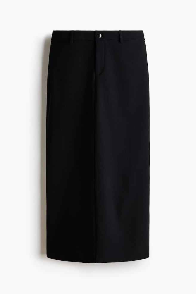 A black, straight-cut midi skirt is facing front, showcasing a tailored waistband with belt loops and a single metallic button closure. It is featuring a concealed fly and a vertical center seam running down the front panel. - 1