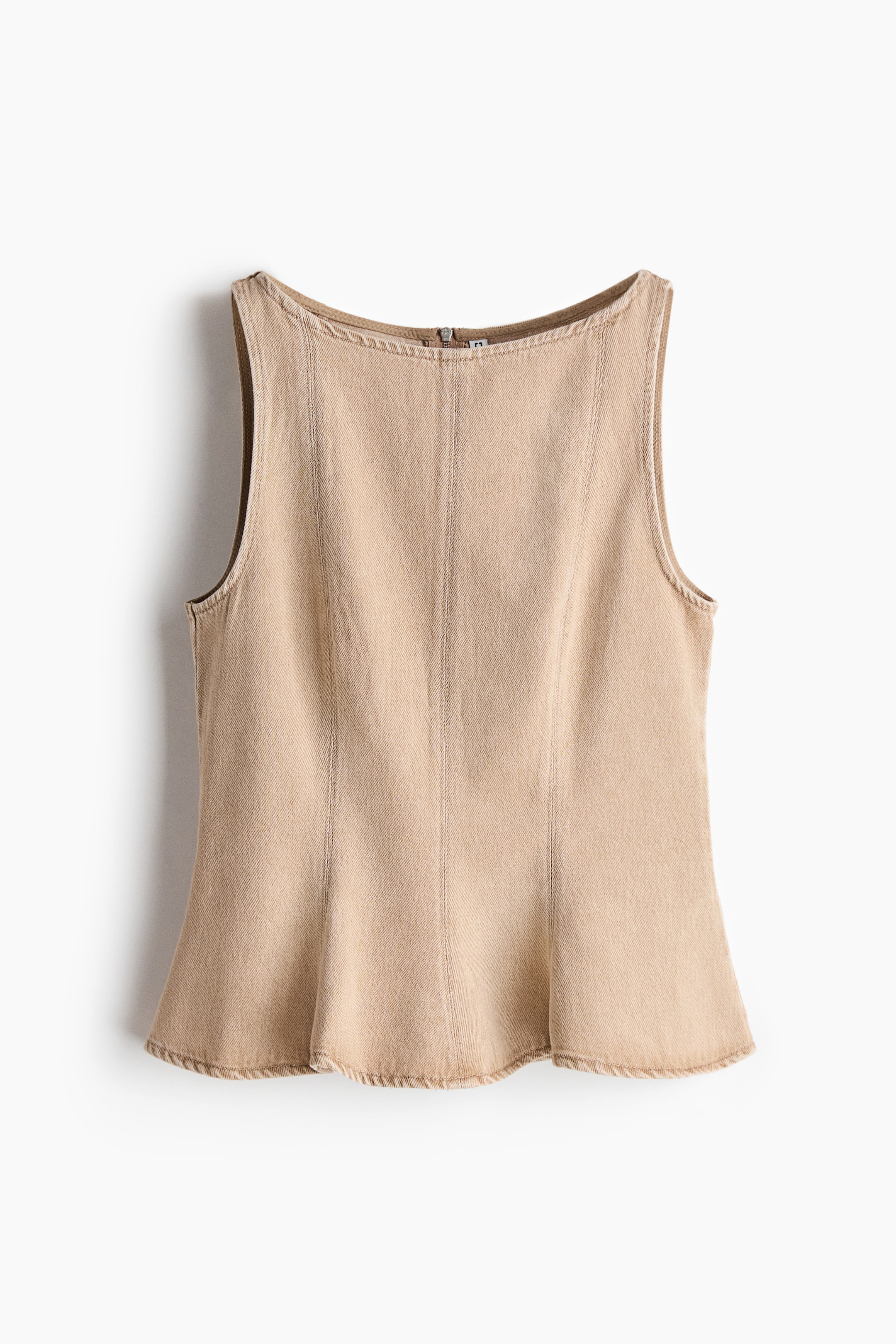 View larger image: A sleeveless top in beige rigid denim is shown from the back, with a boat neckline and a short zip fastening at the top. Vertical shaping seams run down the back to a flared peplum hem.