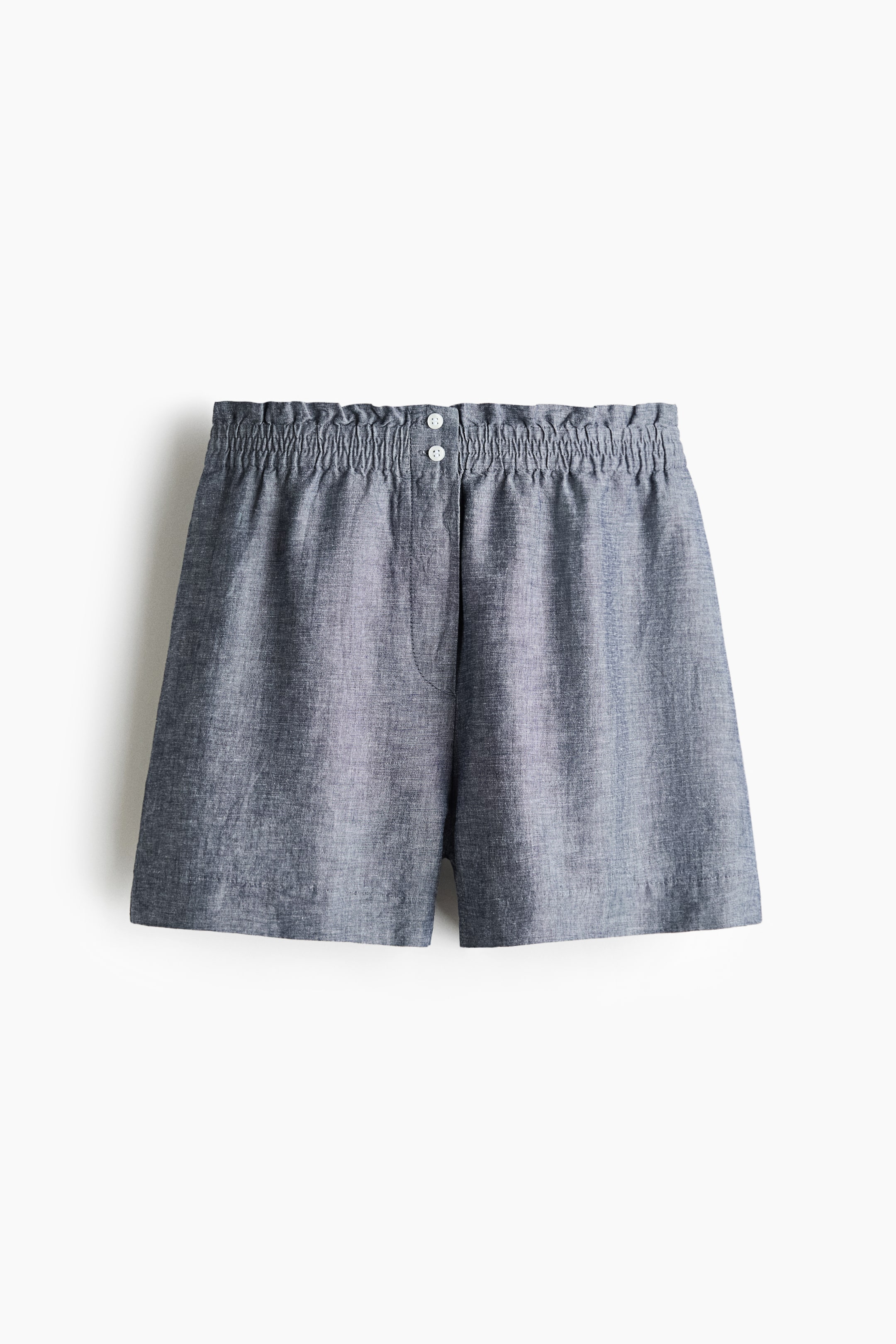 View larger image: These greyish-blue shorts showcase a heathered fabric texture. They feature an elasticated, gathered waistband with two white buttons at the centre front and a visible faux fly detail below.