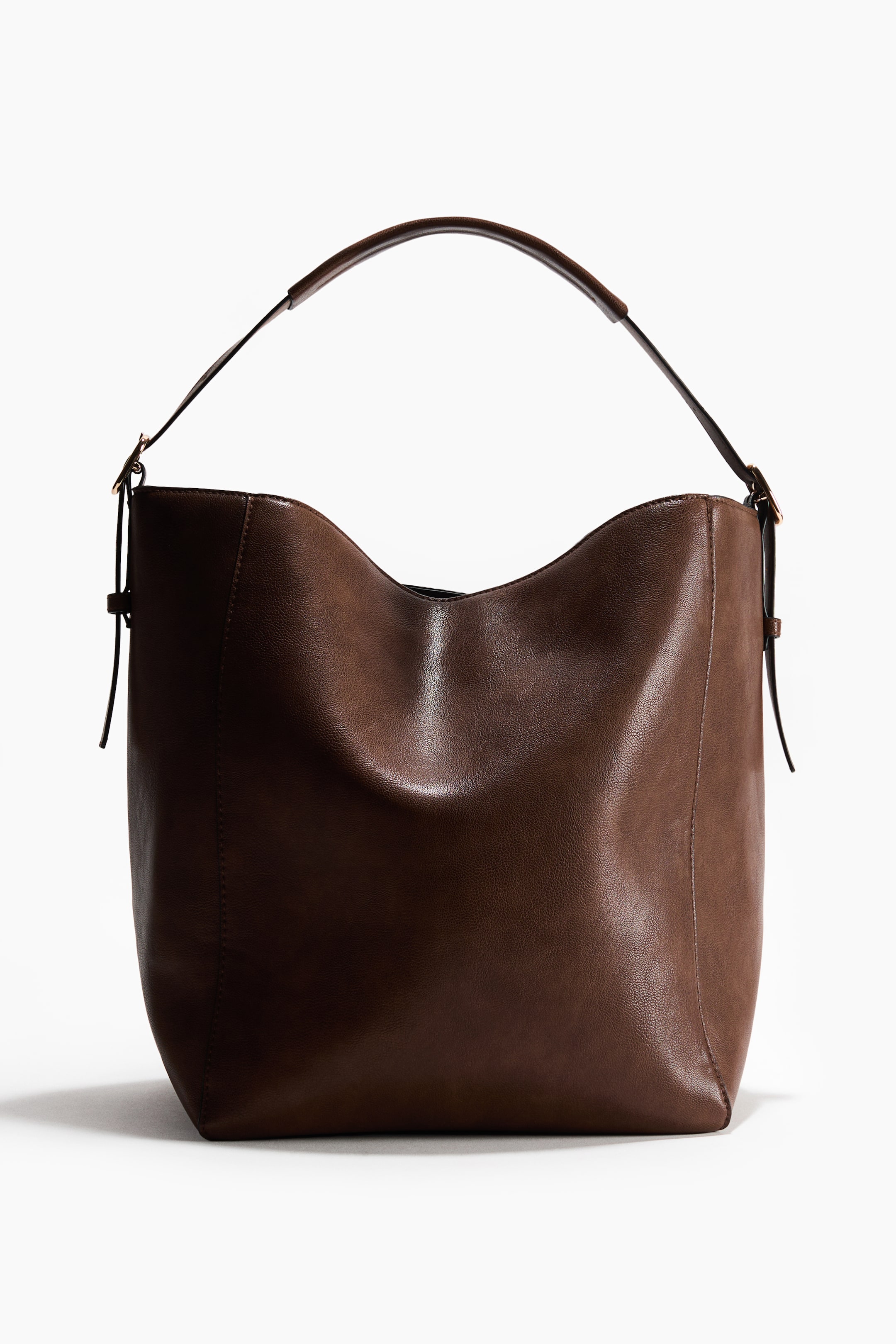 View larger image: A brown hobo bag is shown front-on, featuring a single rounded shoulder strap. It is crafted from a textured, slouchy brown material and includes adjustable side straps with gold-tone hardware.