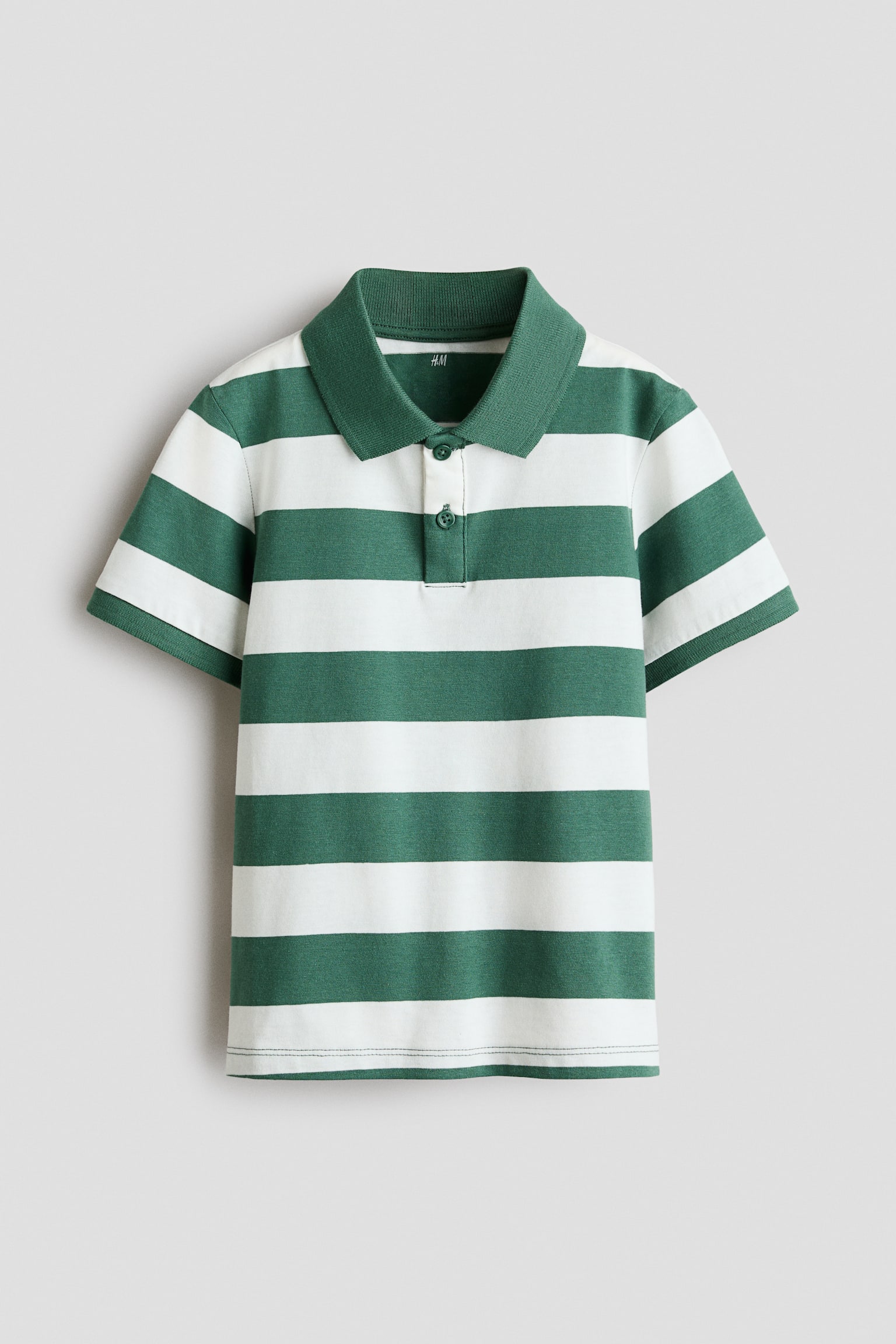 A front view of a polo shirt featuring wide green and white horizontal stripes, a solid green ribbed collar, and a two-button placket. The short-sleeved shirt displays a straight hem, highlighting its classic fit and structure.