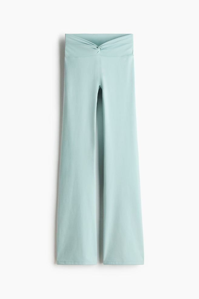 Light-blue wide-leg pants shown from the front, featuring a high waistband with a twisted knot detail. The pants are cut with wide, flowing legs and finished hems. - 1