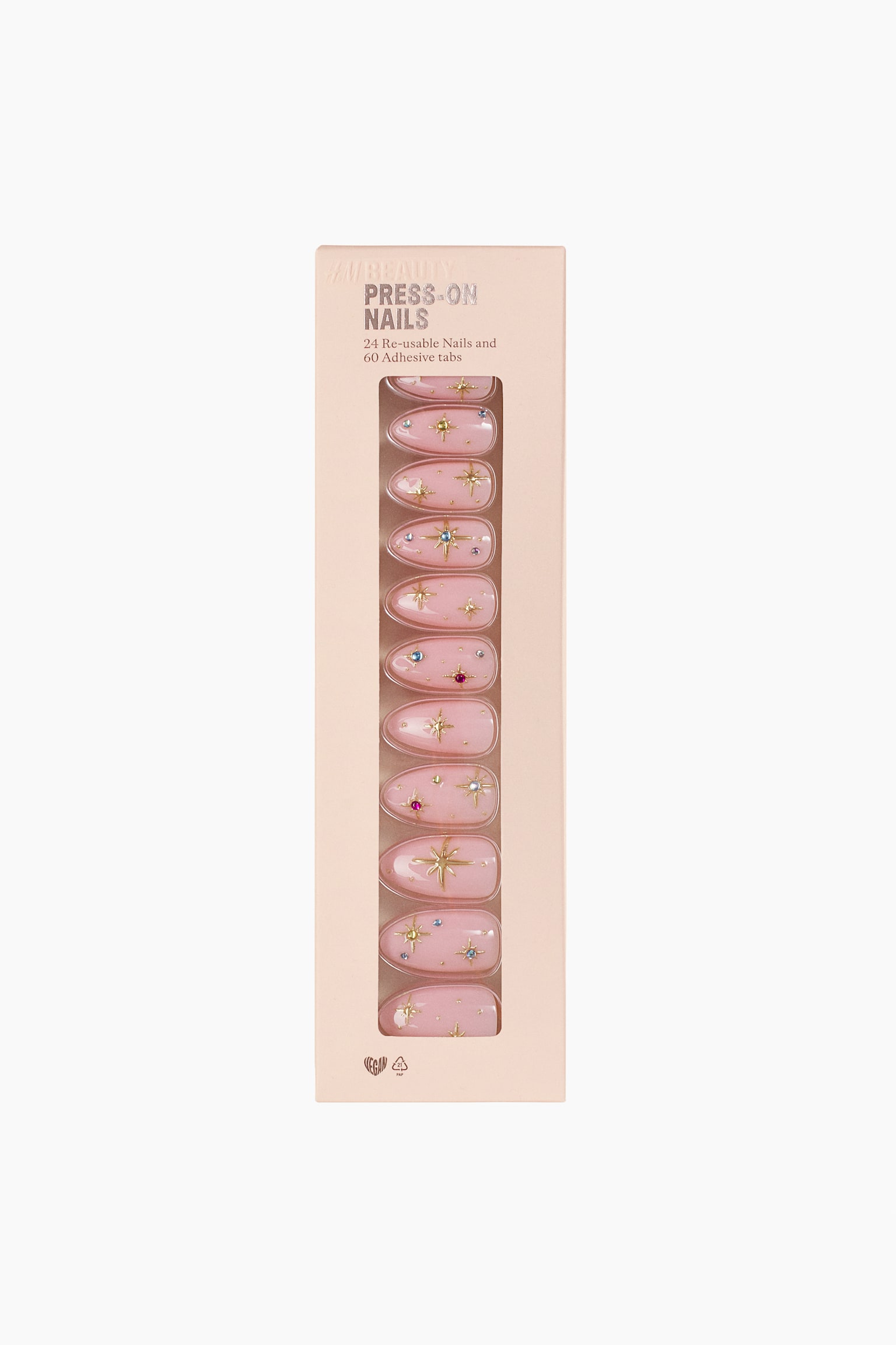 En rektangulär ljusrosa förpackning visar ett set mandelformade press-on-naglar som är vända framåt genom ett vertikalt fönster. De blanka, ljusrosa naglarna pryds av gyllene stjärnformsdesign och små, färgglada strasstenar.