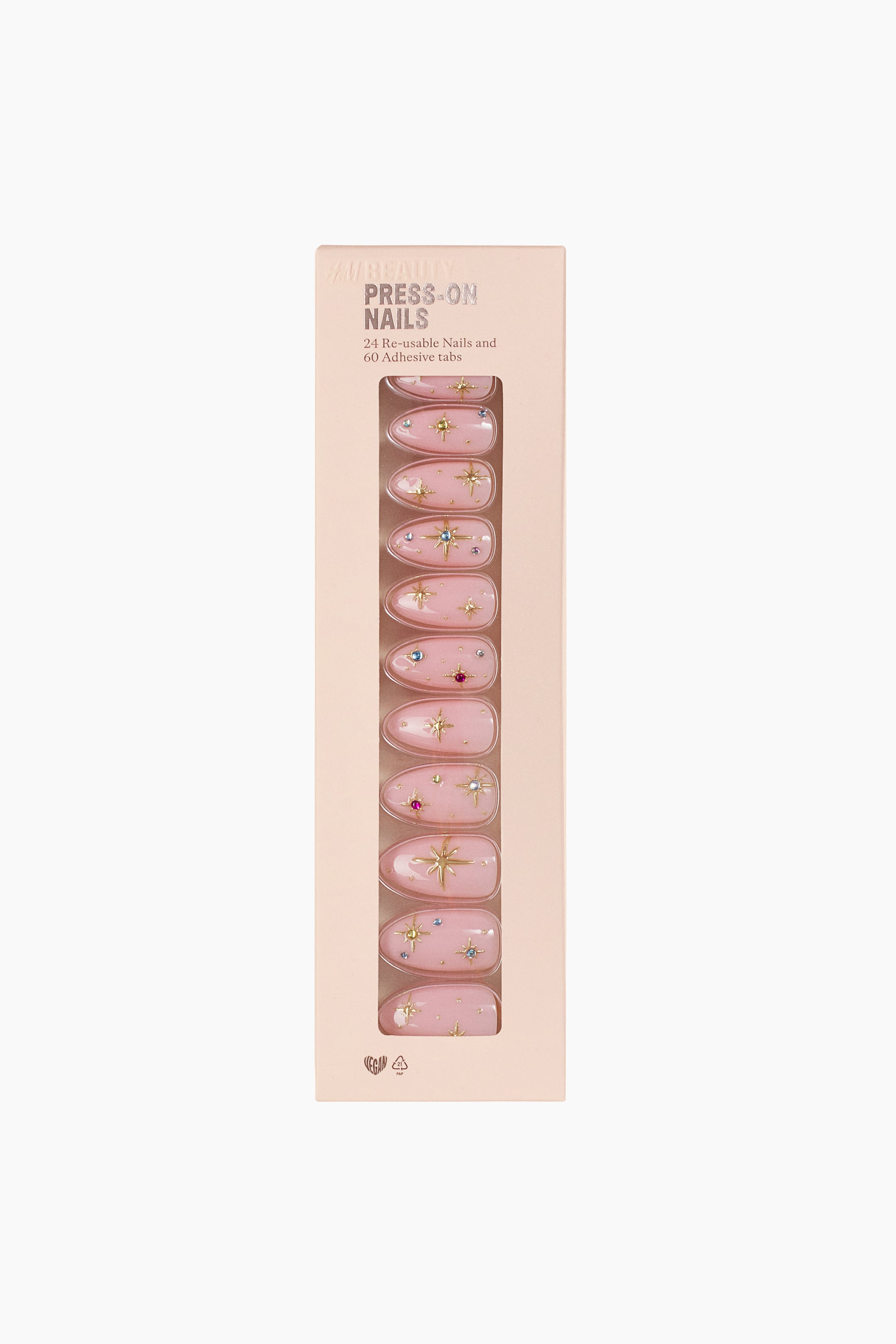 Größeres Bild anzeigen: Eine rechteckige, hellrosa Verpackung zeigt durch ein vertikales Fenster ein Set mandelförmiger Press-on-Nägel in Frontansicht. Die glänzenden, hellrosa Nägel sind mit goldenen Sternenburst-Designs und winzigen, farbigen Strasssteinen versehen.