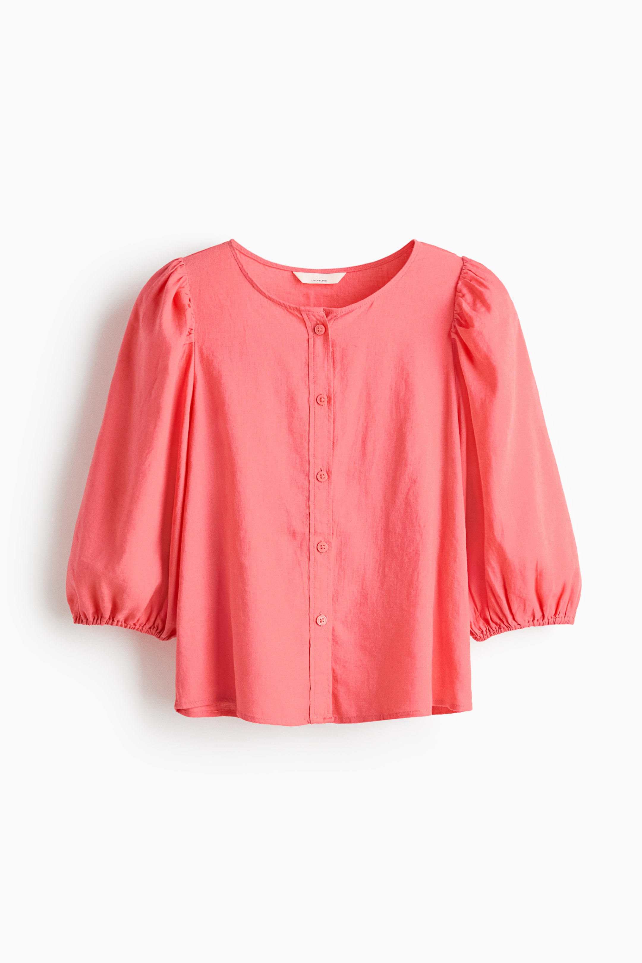 View larger image: Presenting a coral blouse crafted in a light, airy weave, showcasing a round neckline with buttons running down the front. It features 3/4-length balloon sleeves with elasticated cuffs.