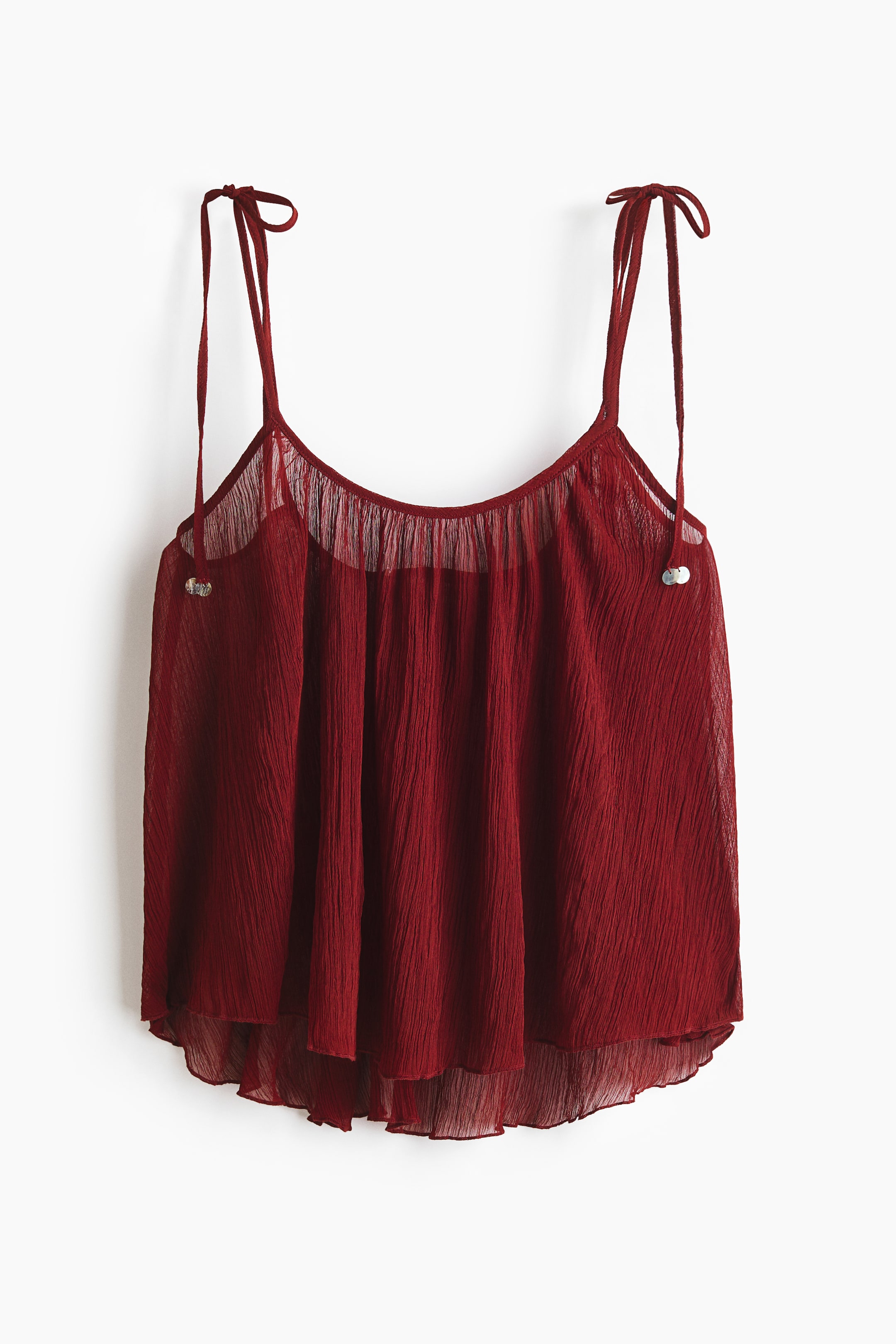 View larger image: A red beach top showcases a sheer, crinkled weave with tie-top shoulder straps, viewed from the front. Pearly sequins embellish the ends of the straps, while gathers add detail around the top, and an overlocked hem completes the bottom edge.