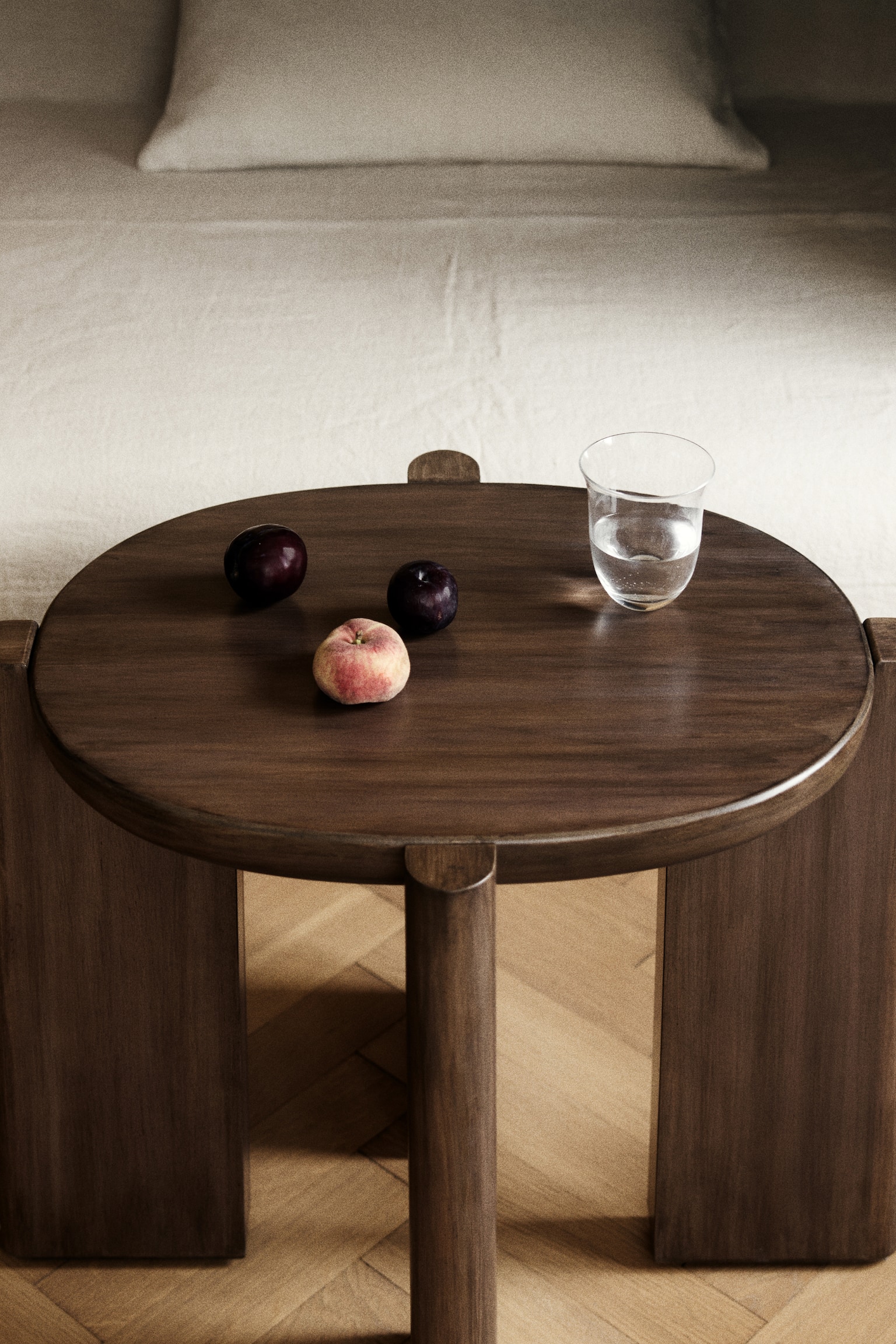 A dark brown wooden table features a round tabletop with a smooth, rounded edge. The tabletop is supported by four thick, rounded-edge legs, which are positioned vertically and slightly angled inward. - 1