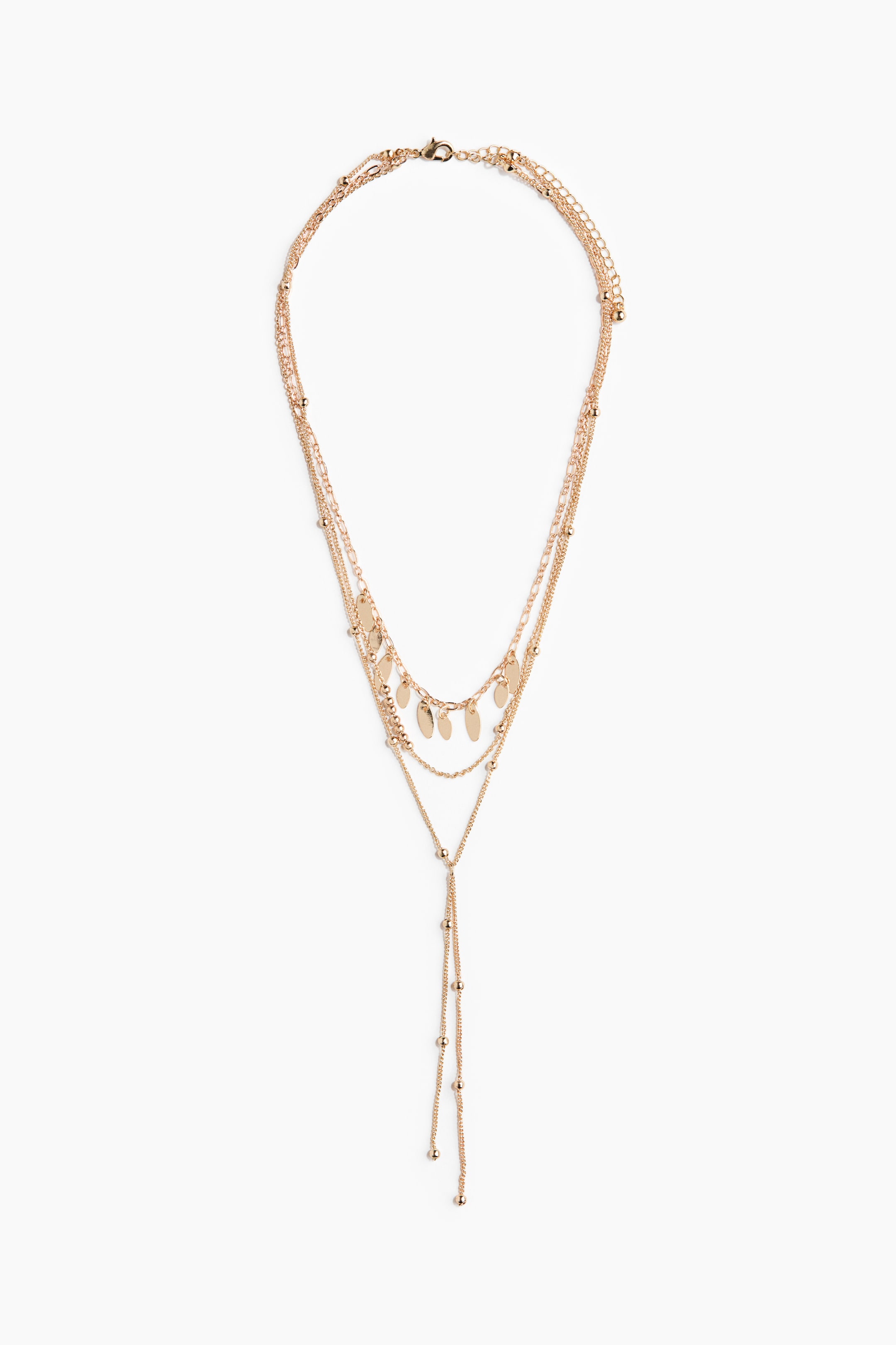 View larger image: A three-strand metal necklace is on display, showcasing its front with a delicate beaded chain, a chain adorned with flat oval charms, and a long Y-shaped strand embellished with small beads. It also features an adjustable length with a trigger clasp.