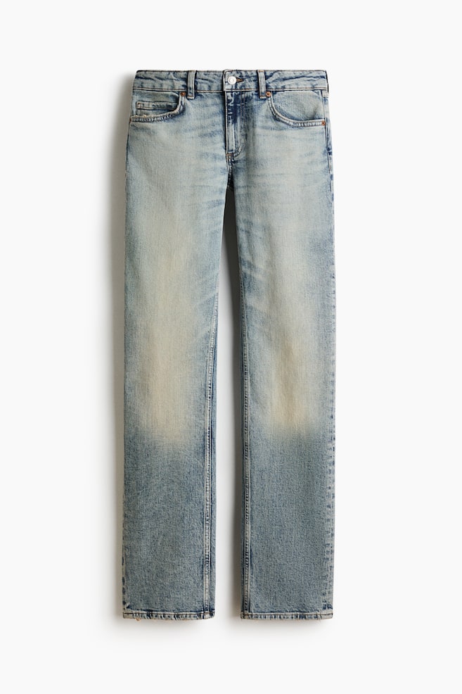 A pair of light blue, straight-leg denim jeans is hanging front-on, showcasing a five-pocket design, belt loops, and a button fastening at the waistband. The jeans feature a faded wash down the front of the thighs and a straight cut through the legs. - 1