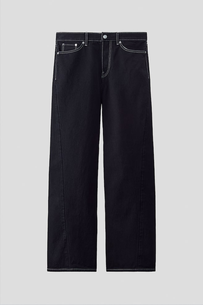 FRONT: Black 5-pocket jeans, crafted from rigid cotton denim, are featuring a loose fit with a straight leg, a dropped crotch, and twisted leg seams. Prominent white contrast stitching is accenting the regular waist, button fly, and overall design, with the legs stacking at the ankle. - 1