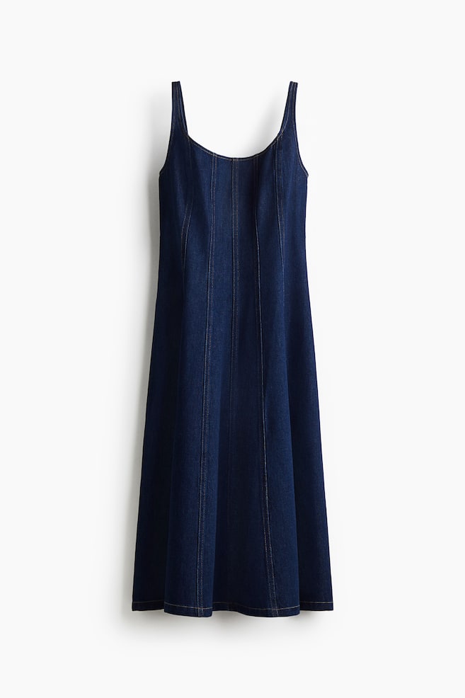 A dark wash denim midi dress is presenting from the front, featuring a scoop neckline, wide shoulder straps, and vertical seam lines with contrast stitching running down the front to a subtly flared A-line hem. - 1