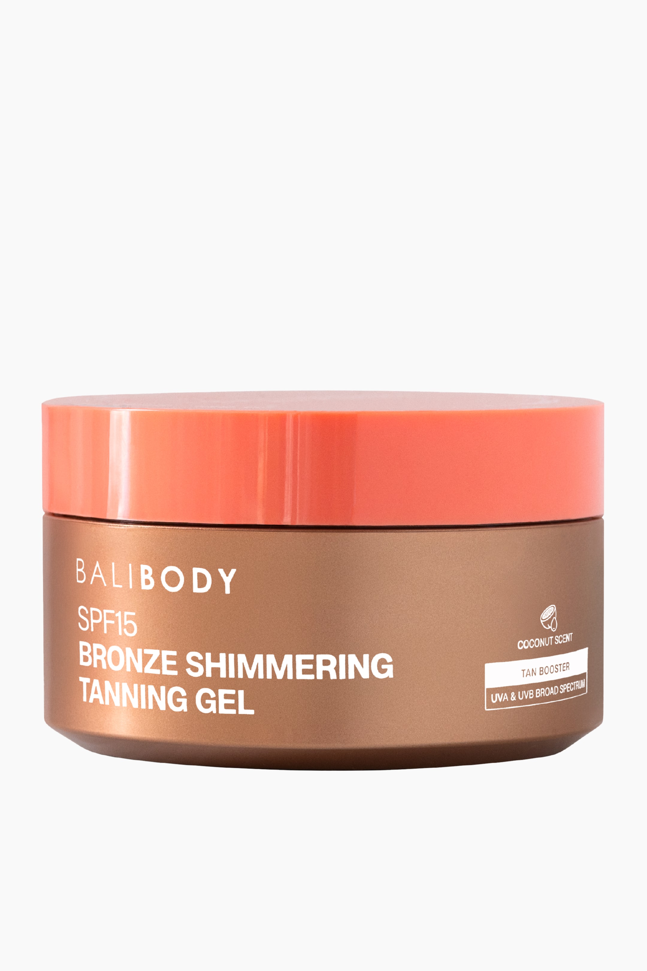 Se større billede: En Balibody SPF15 Bronze Shimmering Tanning Gel præsenteres i en metallisk bronze rund krukke med et glansfuldt koralorange låg, der vender fremad. Hvid tekst mærker forsiden af krukken med 'Balibody SPF15 Bronze Shimmering Tanning Gel', og mindre hvid tekst på højre side angiver 'Kokosduft', 'Tan Booster' og 'UVA & UVB Bredt Spektrum'.