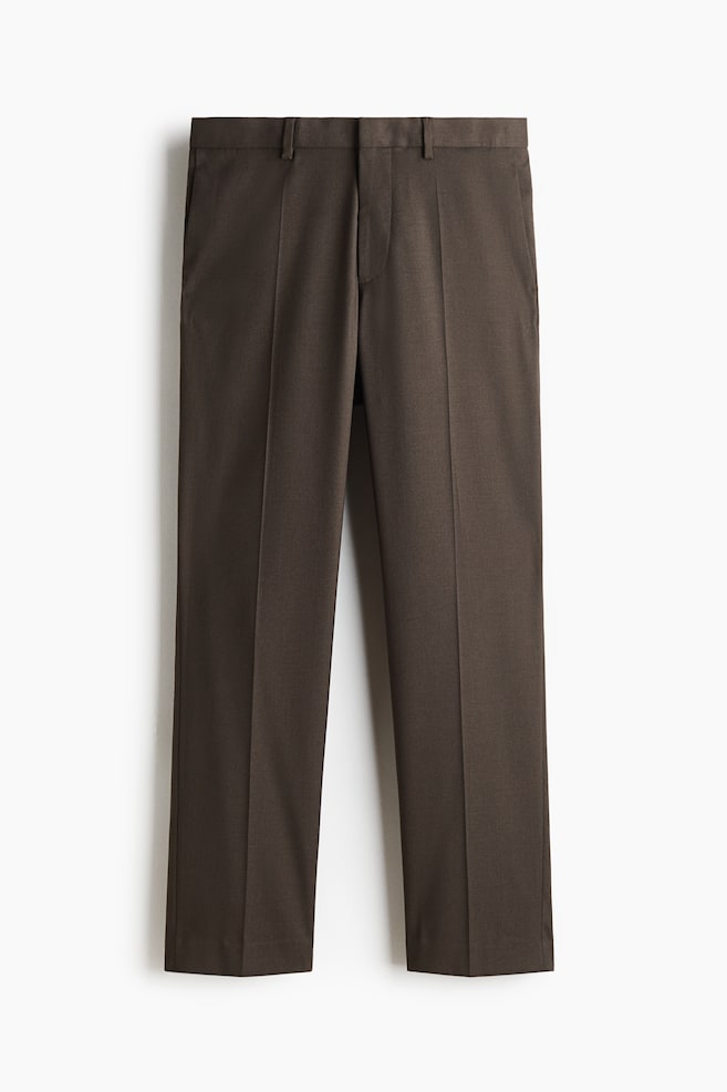 A pair of dark brown tailored trousers is shown front-on, featuring a straight-leg silhouette with crisp pressed creases running down the centre of each leg. The trousers display a structured waistband with belt loops and subtle side slip pockets. - 1