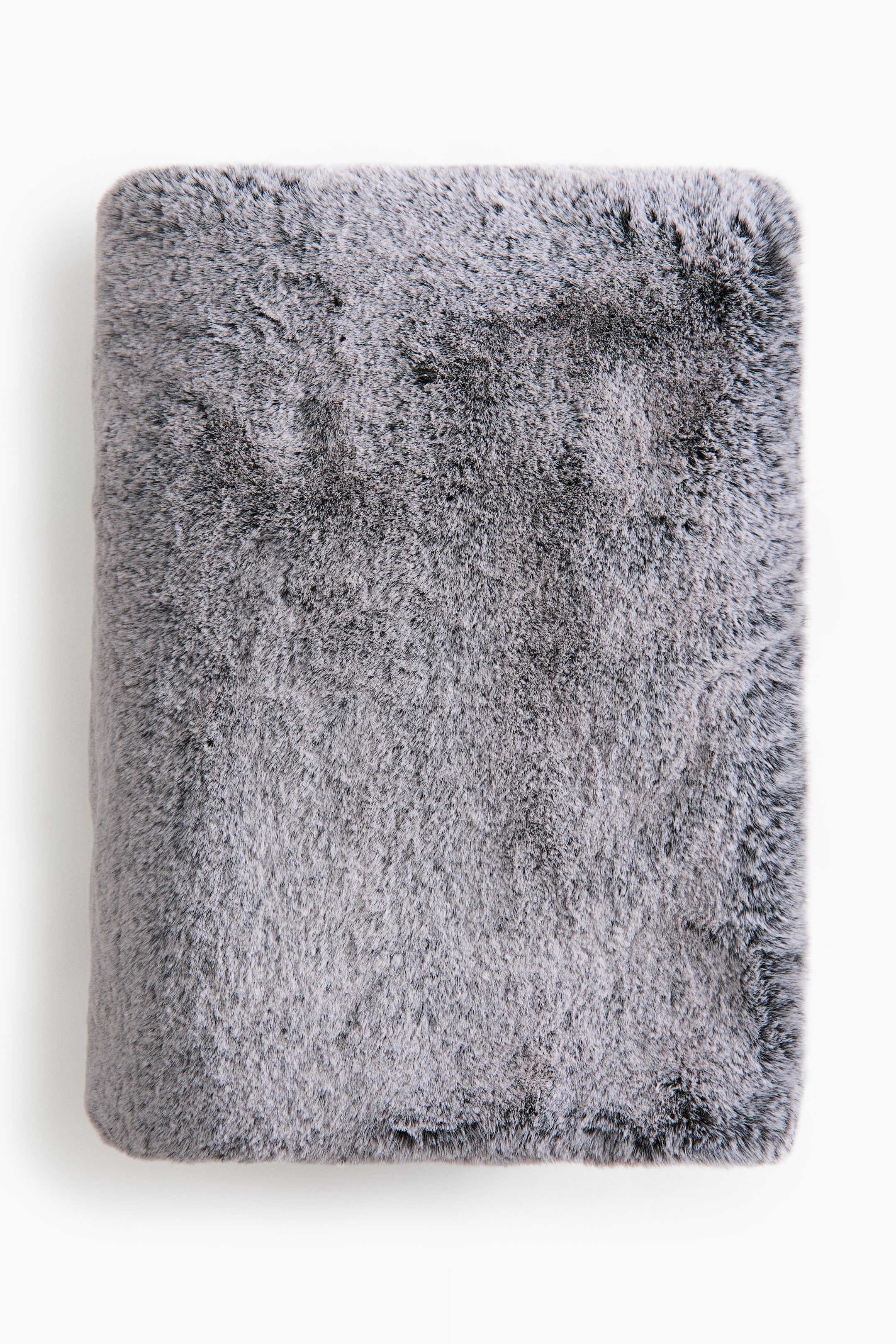 View larger image: A folded grey faux fur blanket displays a thick, plush texture with dark grey and black undertones. The blanket is folded into a neat rectangle, showcasing its soft, dense pile from a front-facing view.