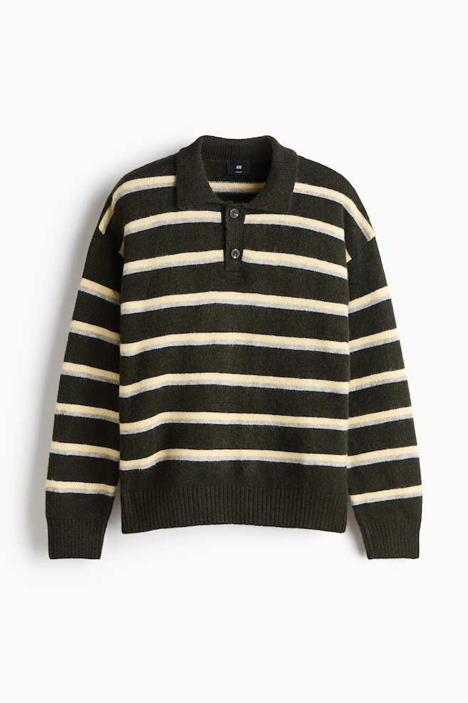 A long-sleeved knit polo jumper is shown from the front, featuring horizontal stripes in dark green, pale yellow and light grey. The garment has a polo collar with a two-button placket, dropped shoulders, and ribbed cuffs and hem. - 1