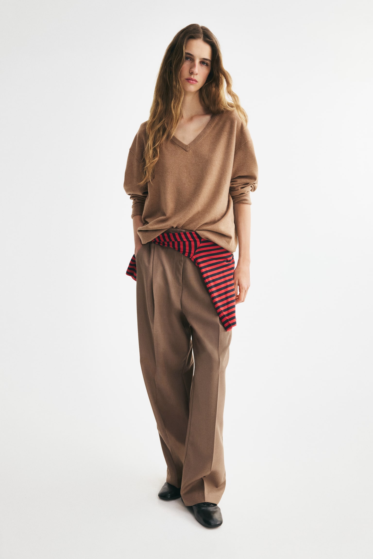 A camel brown V-neck jumper is facing forward, featuring long sleeves with ribbed cuffs and a ribbed hem. - 1