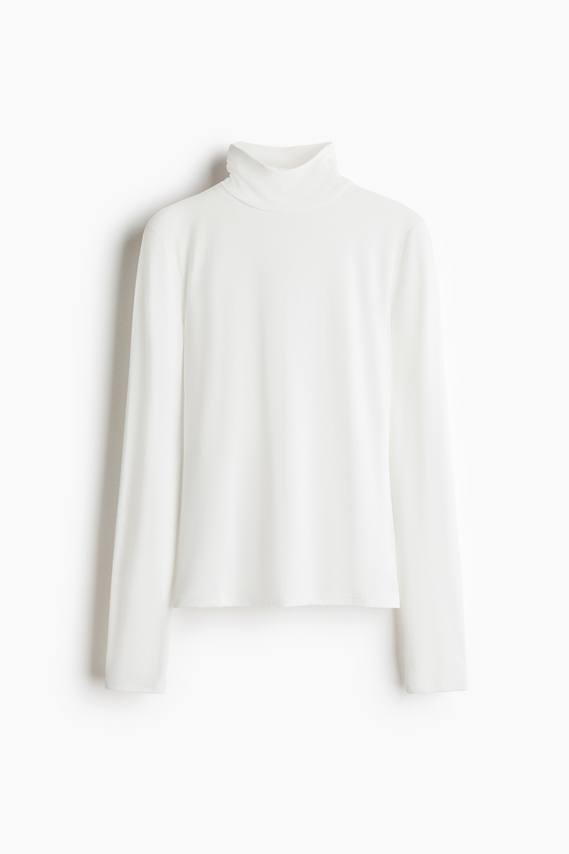 View larger image: A white, rib-knit roll-neck top is shown from the front, featuring long sleeves and a straight hem.