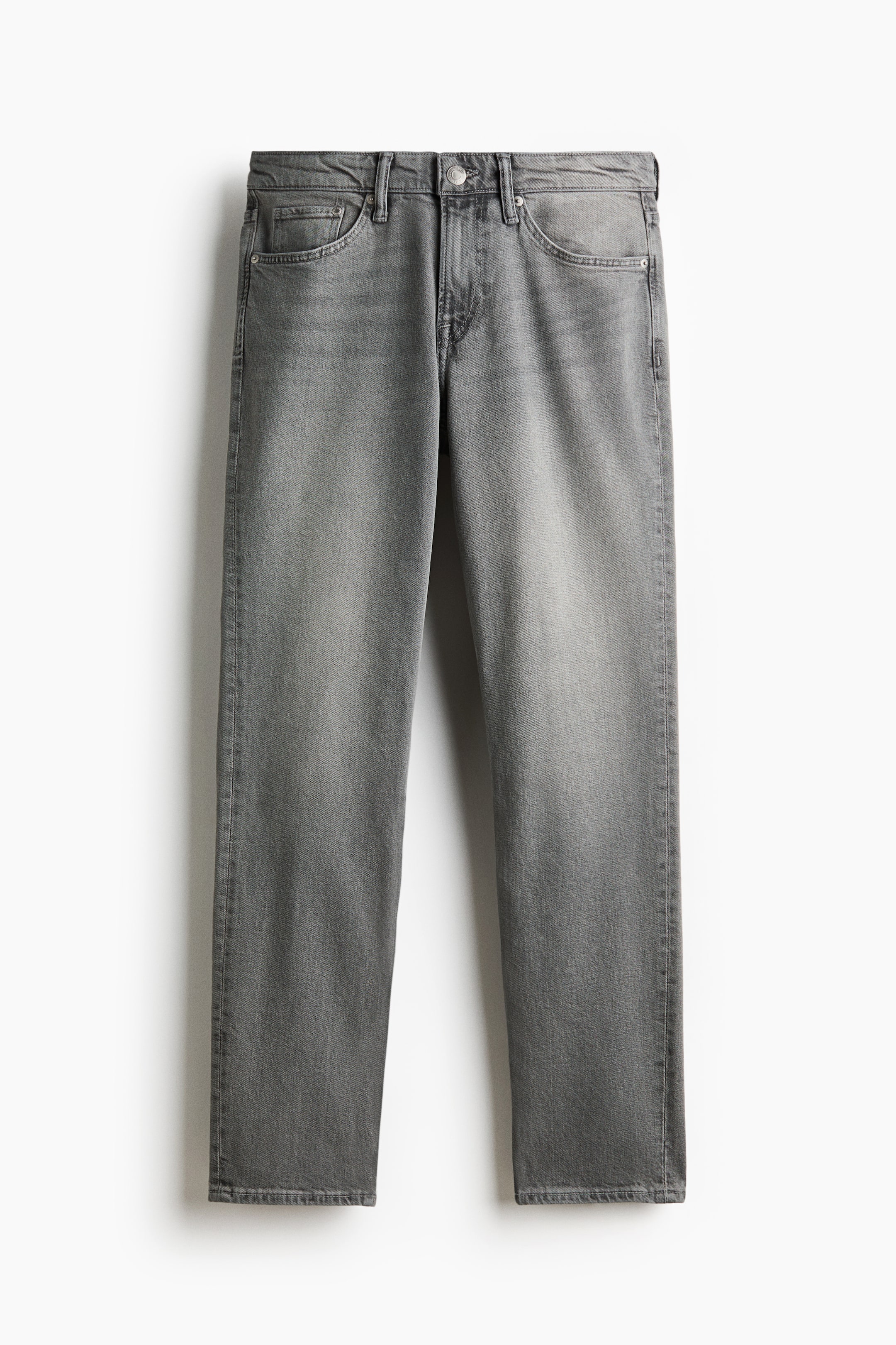 View larger image: Grey jeans are hanging vertically, facing front. They feature a washed finish, belt loops, a button closure, curved front pockets, and a coin pocket.