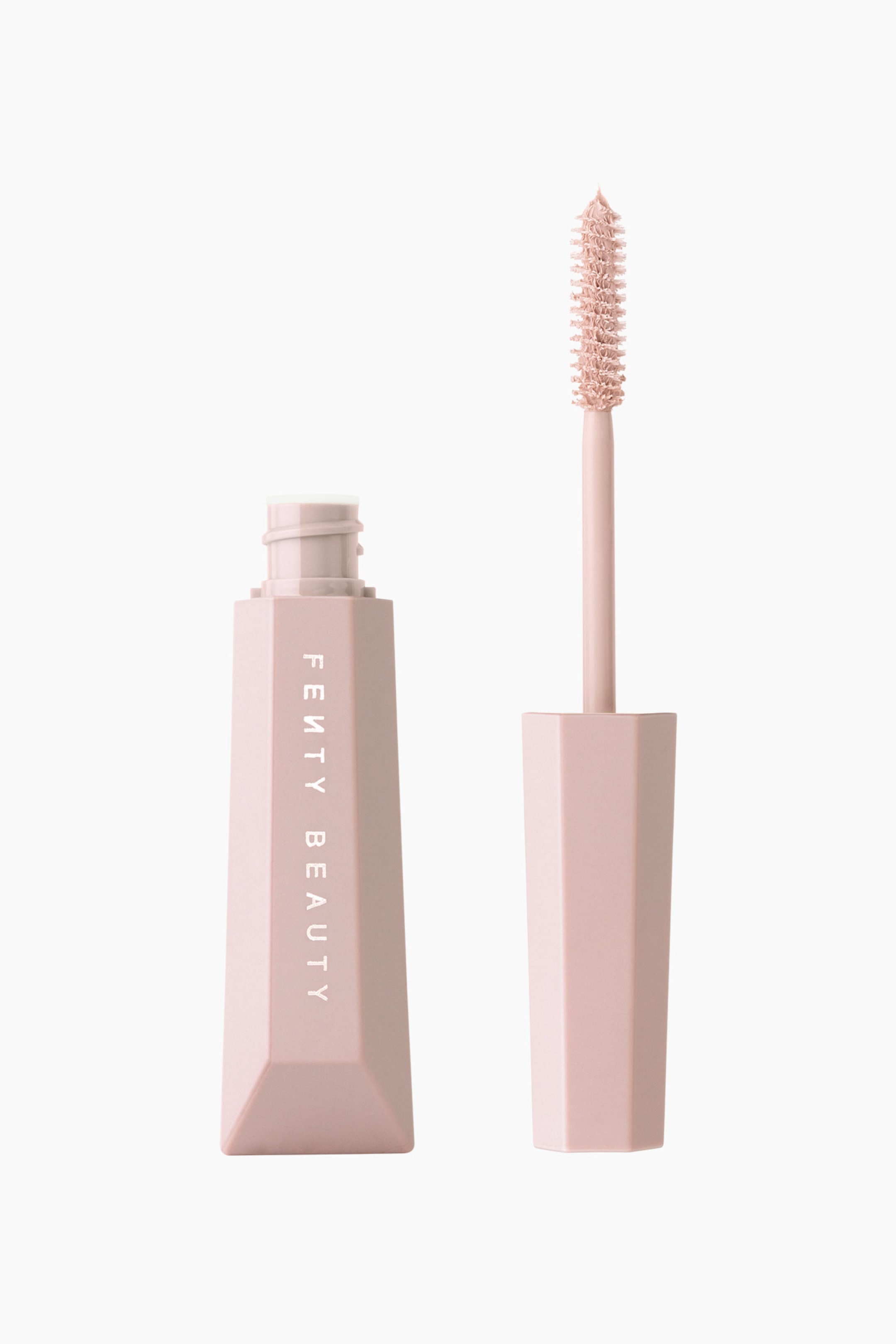 Visa större bild: Hella Extra Mascara-boosting Lash Primer står upprätt och visar sin öppna, ljusrosa sexkantiga tub med "FENTY BEAUTY" tryckt lodrätt i vitt. Bredvid tuben håller det matchande sexkantiga locket upp borsten upprätt och avslöjar en borstförsedd applikator pensel täckt av en ljusrosa formula.