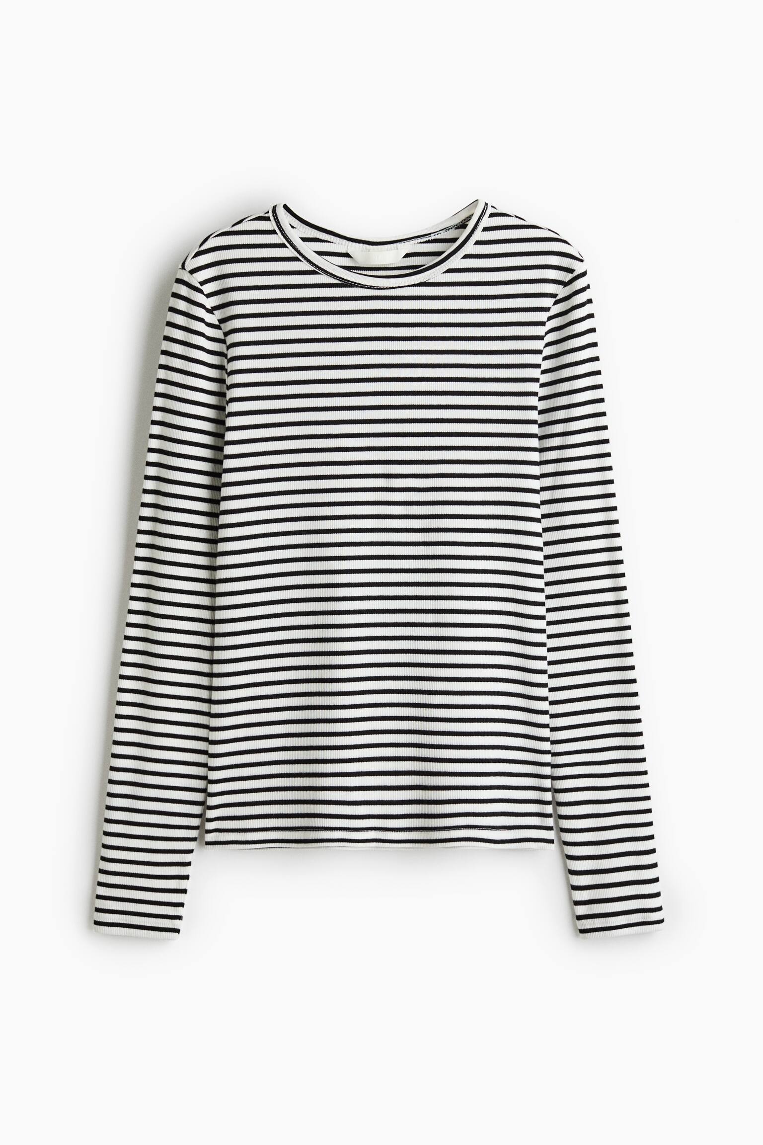 A long-sleeved fitted top in ribbed cotton jersey is shown from the front, featuring horizontal black and white stripes. The top features a round neckline and long, straight sleeves.