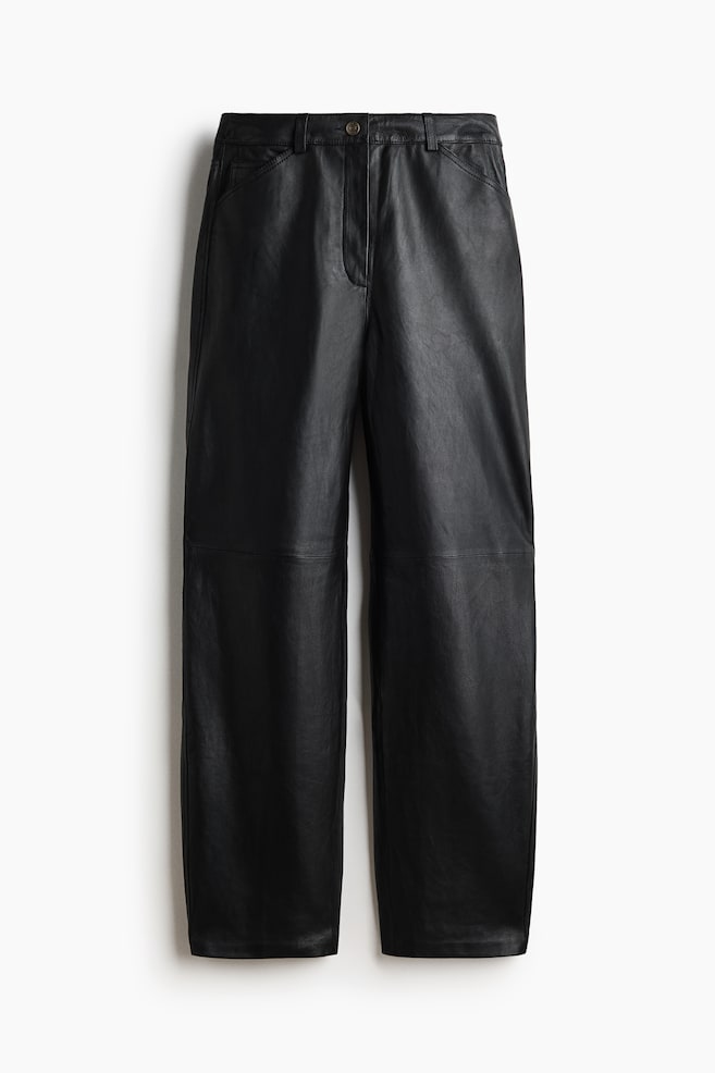 Black leather trousers are shown from the front, featuring a high-rise waist with belt loops, a button and zip-fly closure, and subtle side pockets. The trousers are designed with a wide-leg silhouette and horizontal seam details across the knees. - 1