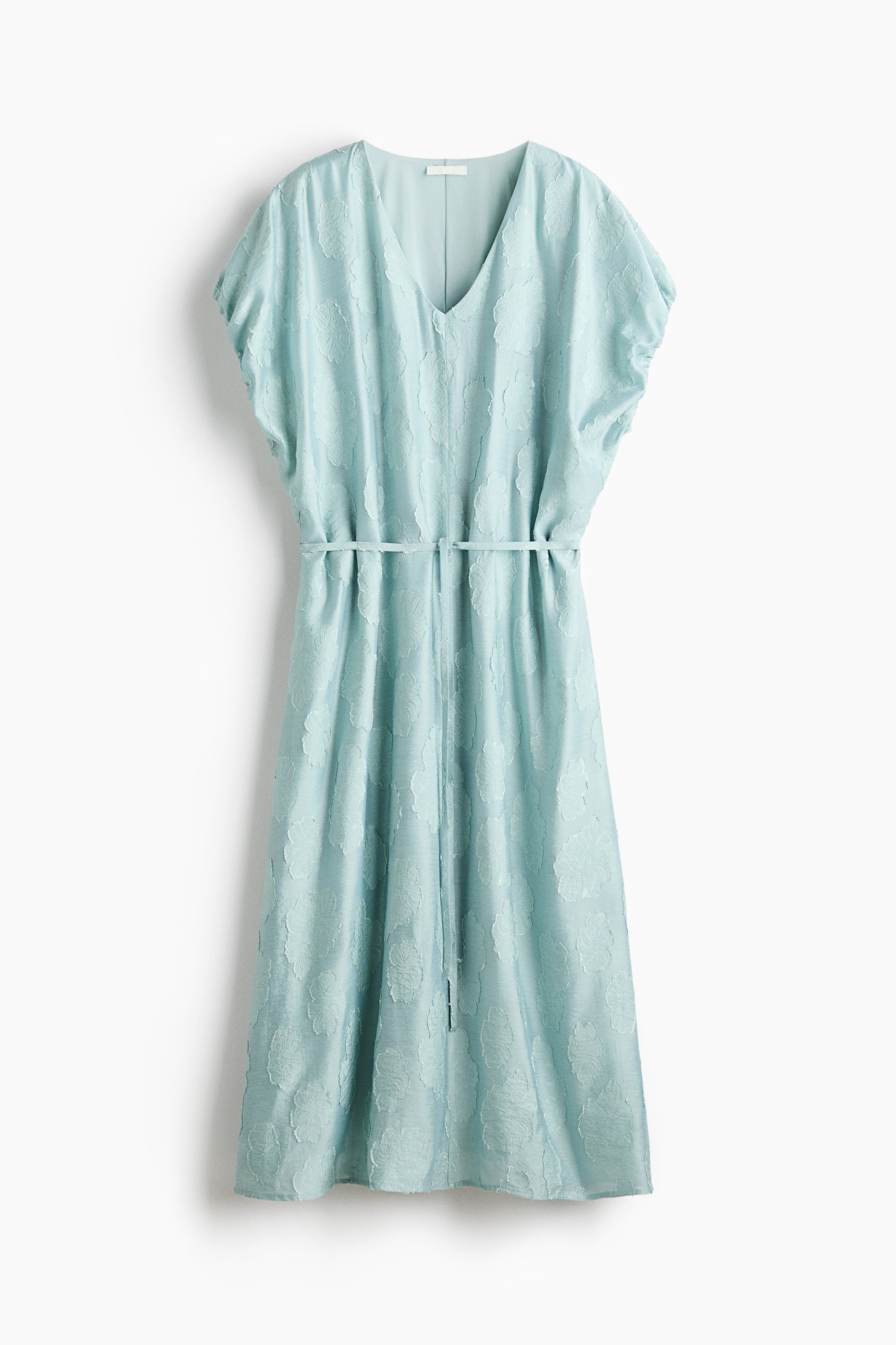 View larger image: The dress is in a light blue shade, showcasing a delicate embossed floral design. It features a V-neckline and short, airy sleeves. A slender self-fabric belt elegantly cinches the waist of this midi-length attire.