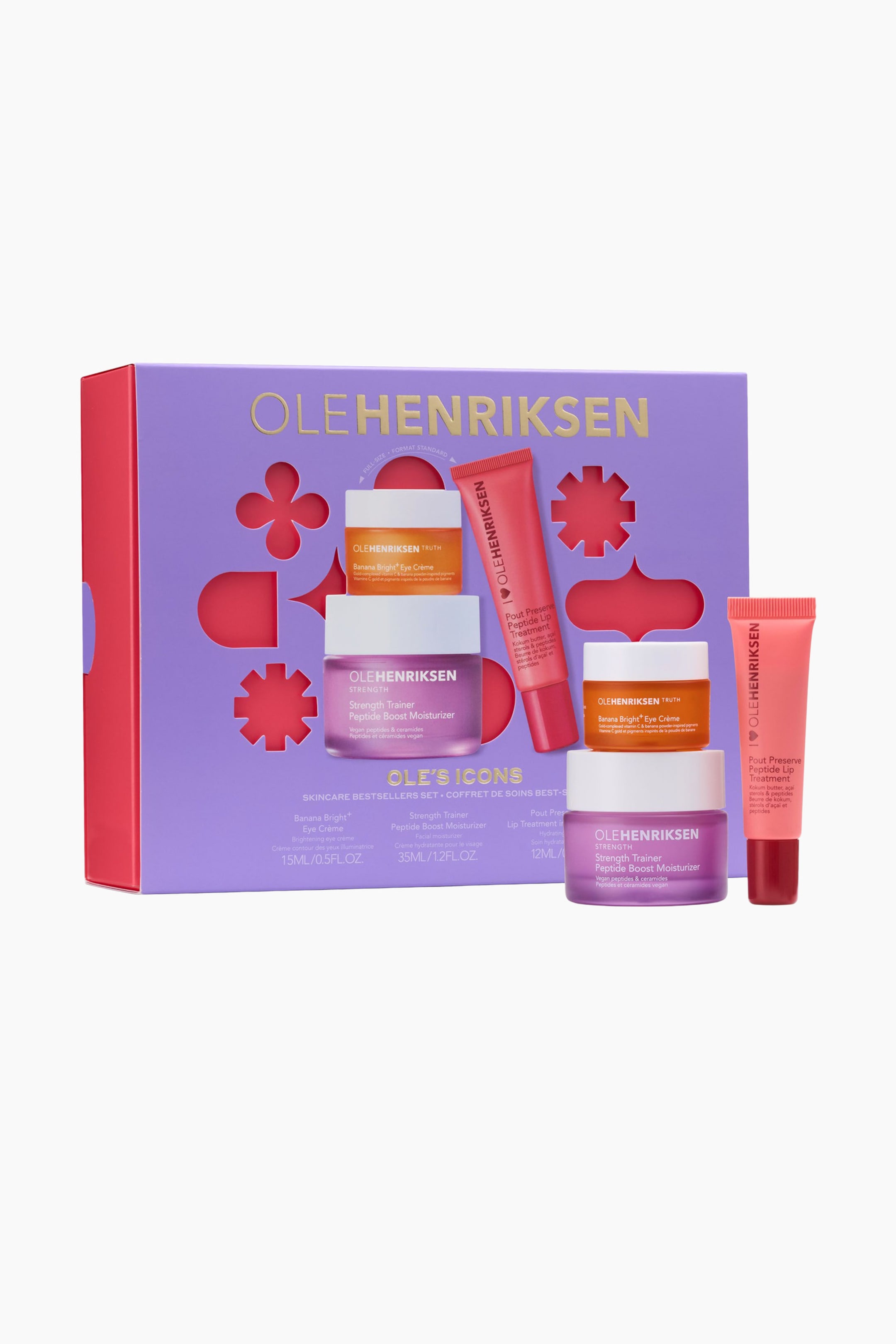 Se større billede: Et Olehenriksen hudplejesæt fremvises i en lilla æske med dekorative udskæringer, der afslører et rødt indre, præsenteret fra en let hævet frontvinkel. Seks individuelle hudplejeprodukter, herunder orange krukker, lilla krukker og koralfarvede tuber, er arrangeret foran og oven på æsken, mærket 'Banana Bright Eye Crème', 'Strength Trainer Peptide Boost Moisturizer' og 'Pout Preserve Peptide Lip Treatment'.