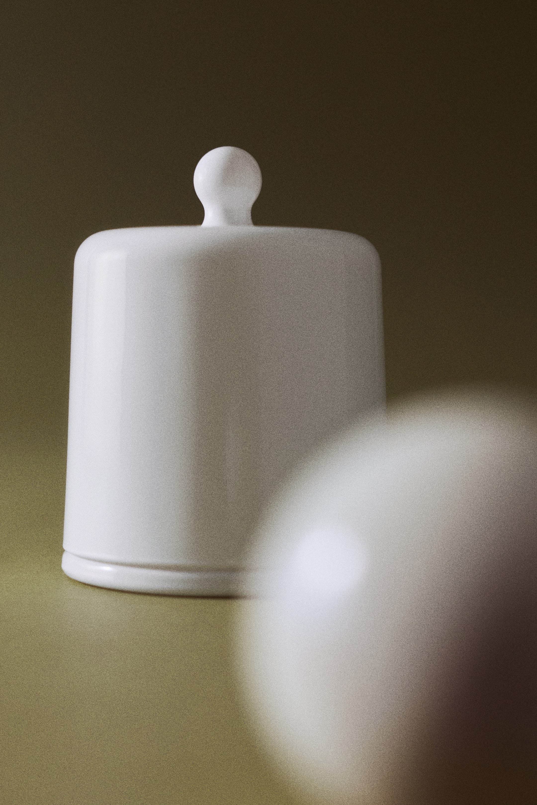 View larger image: A white opaque glass candle holder is standing upright, featuring a matching dome-shaped cloche lid with a rounded knob handle on top.