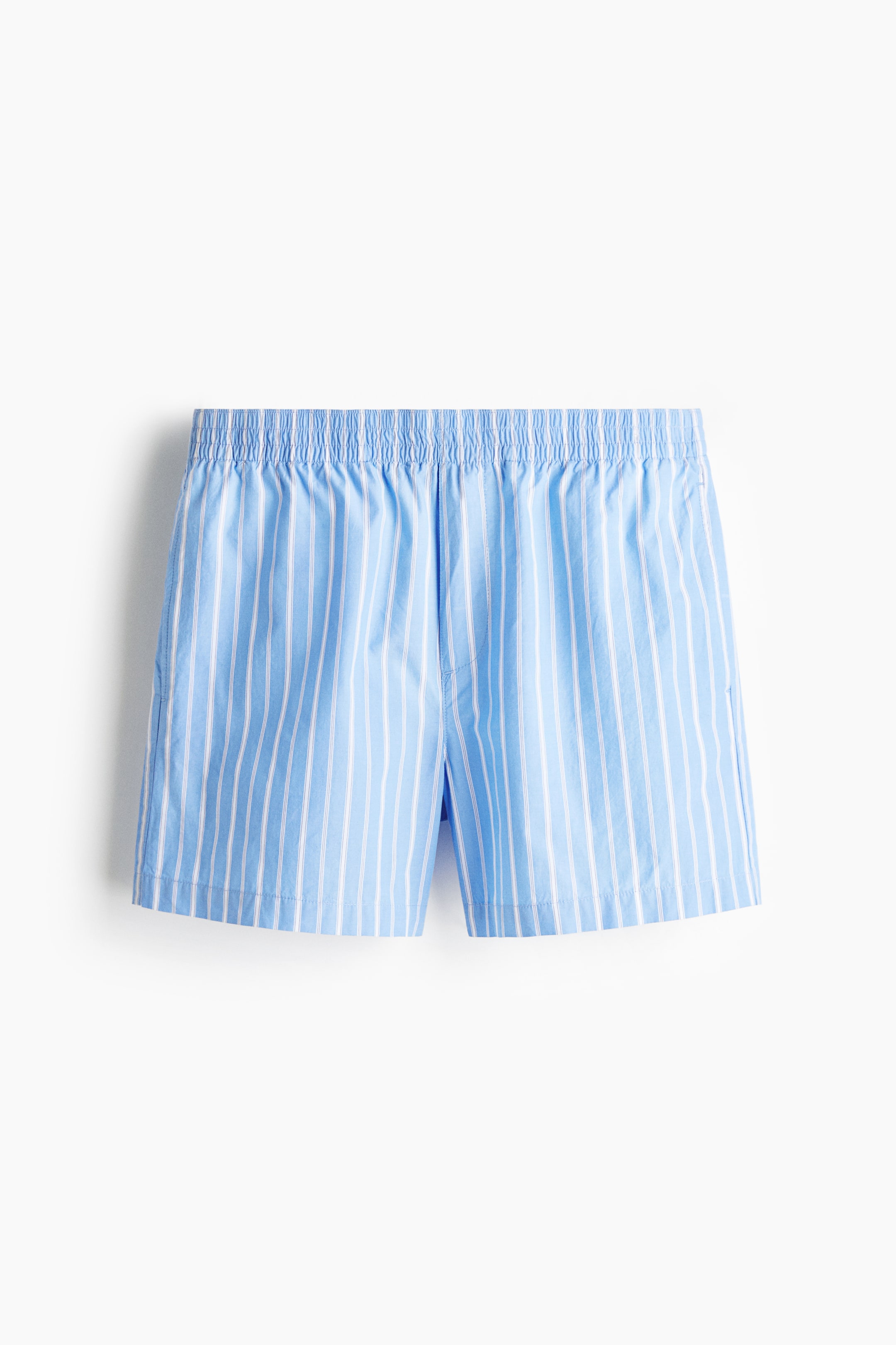 View larger image: The boxer shorts are showcased from the front, highlighting a light blue fabric adorned with vertical white stripes. They come with an elasticated, gathered waistband and a stitched fly opening at the center front.