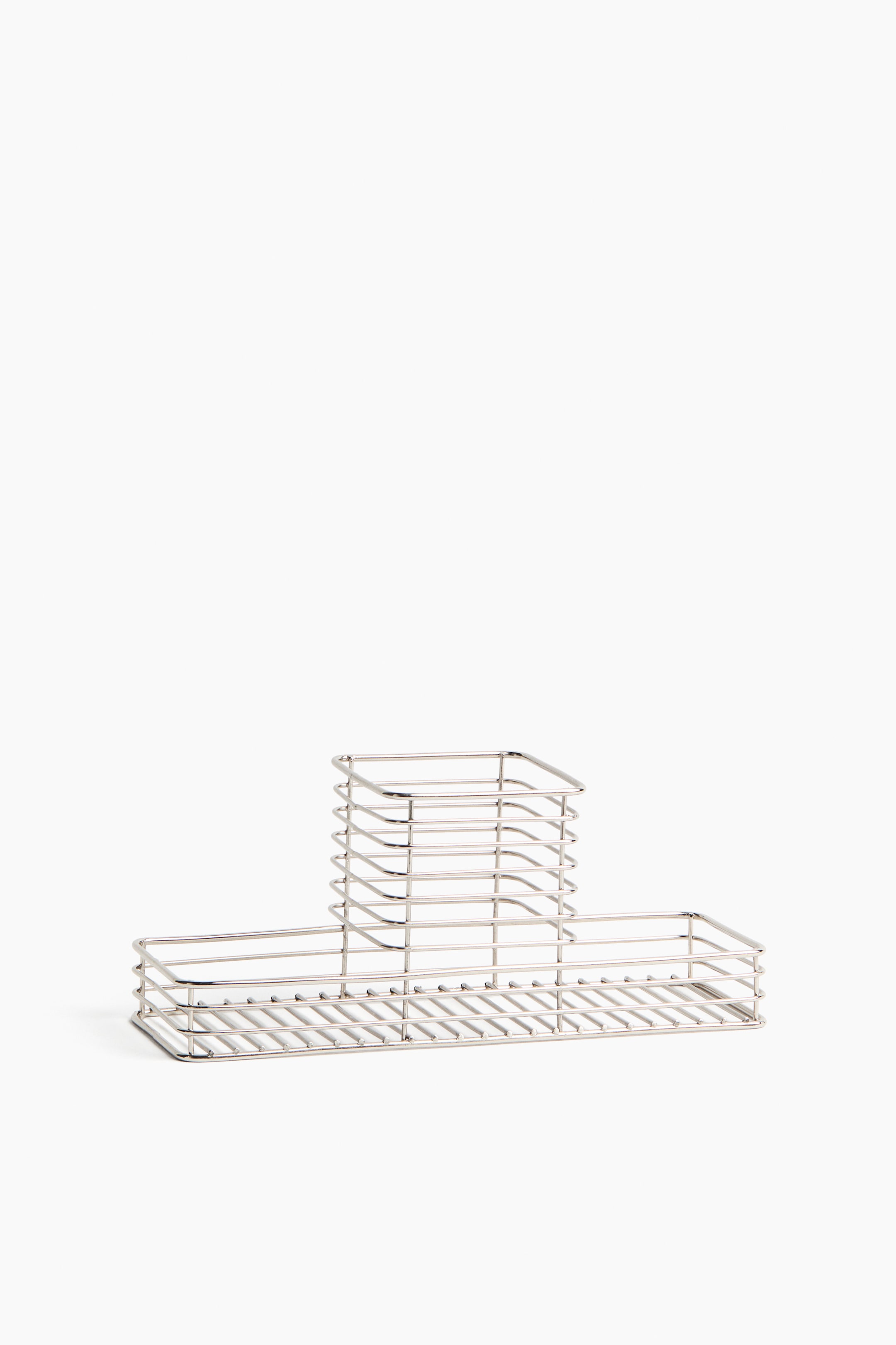 View larger image: A silver-toned wire organizer features a rectangular base with a taller square compartment rising from the back center, and two lower rectangular compartments extending from the sides. All sections are constructed from parallel metal wires forming a grid pattern.