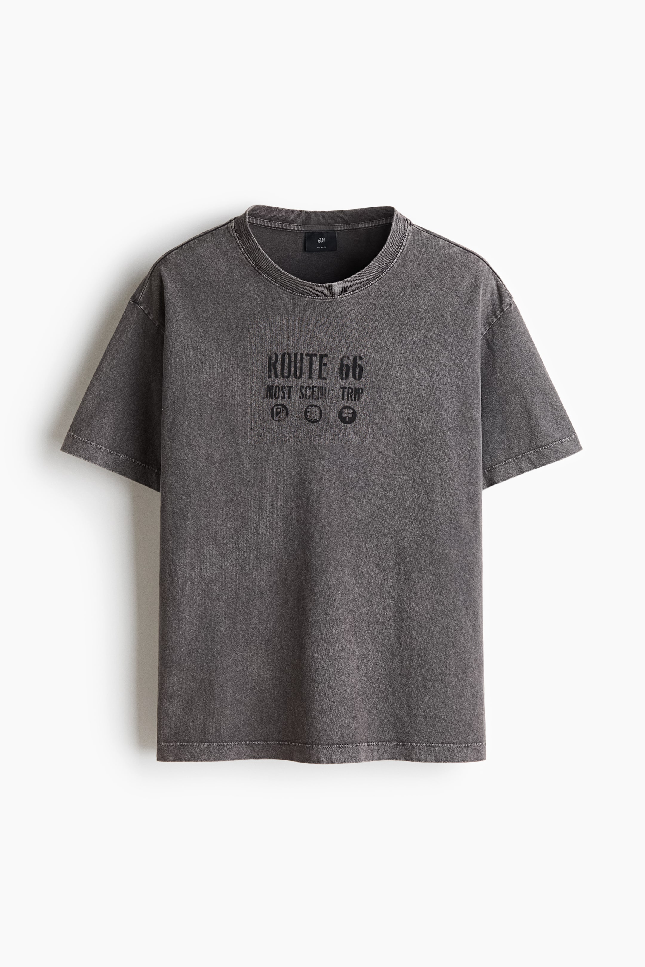 View larger image: A dark grey, washed cotton jersey t-shirt is facing front, featuring a round, rib-trimmed neckline, dropped shoulders, short sleeves, and a straight-cut hem. This relaxed-fit t-shirt is displaying a "ROUTE 66 MOST SCENIC TRIP" print with three circular icons on its front.