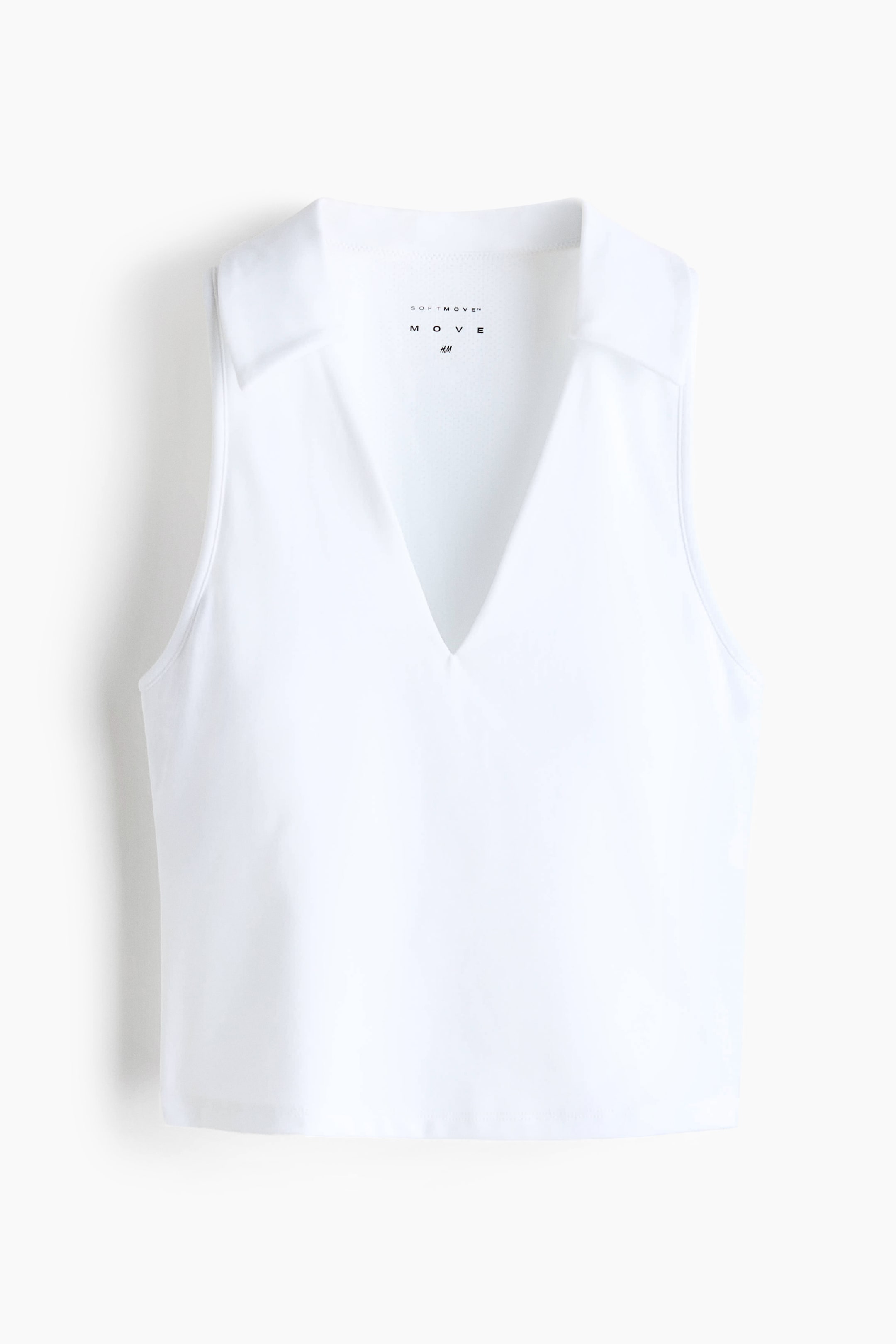 View larger image: A white sleeveless top features a spread collar and a deep V-neck opening at the front. The garment has a straight hem, and the brand tag 'SOFTMOVE MOVE H&M' is visible on the inside back neck.