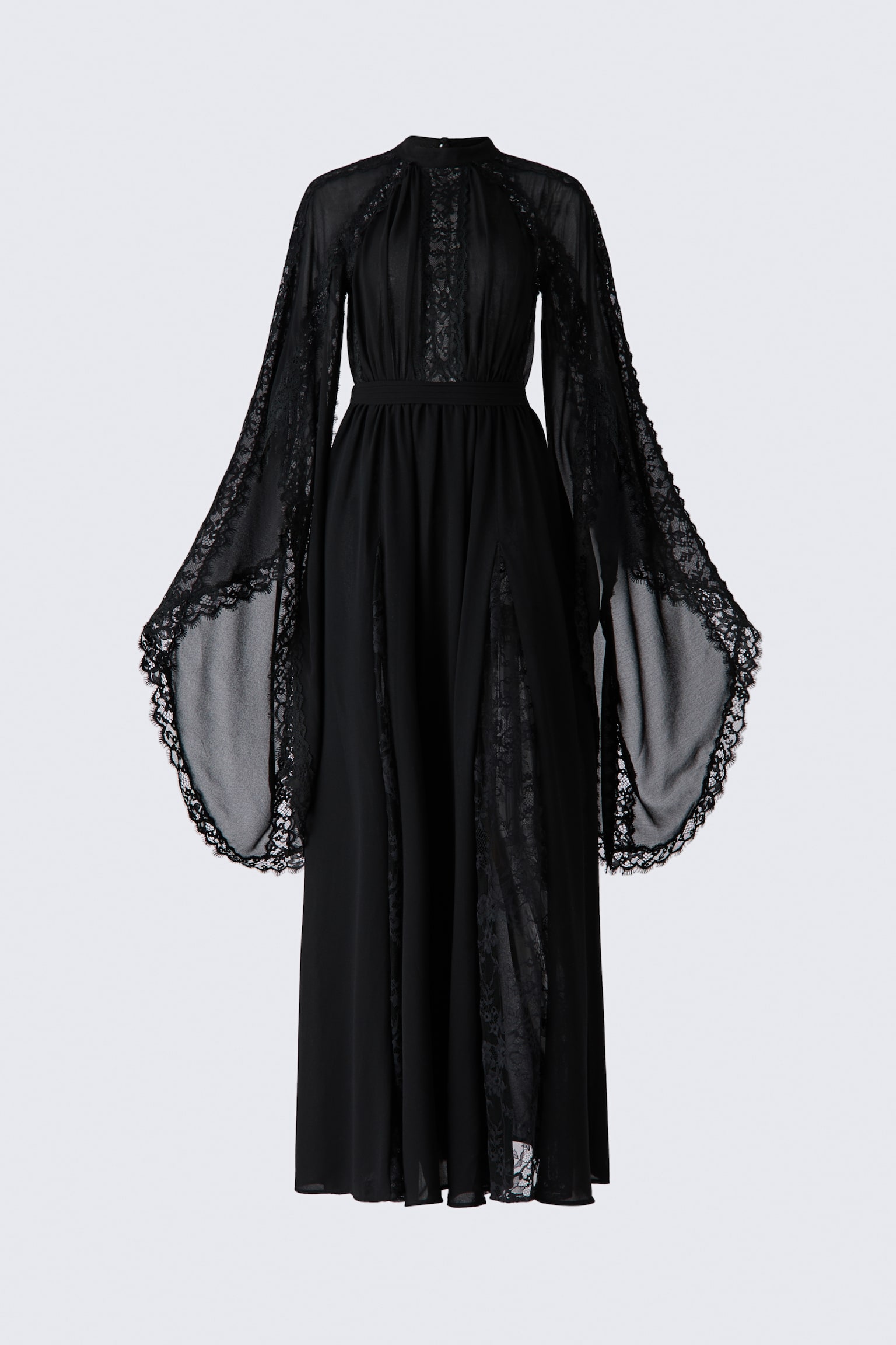 A black floor-length dress is shown from the front, featuring sheer chiffon fabric embellished with lace inserts and trims. The dress is designed with a high band collar, dramatic, wide-flaring raglan sleeves with open slits, and a flowing skirt with lace godet pleats.