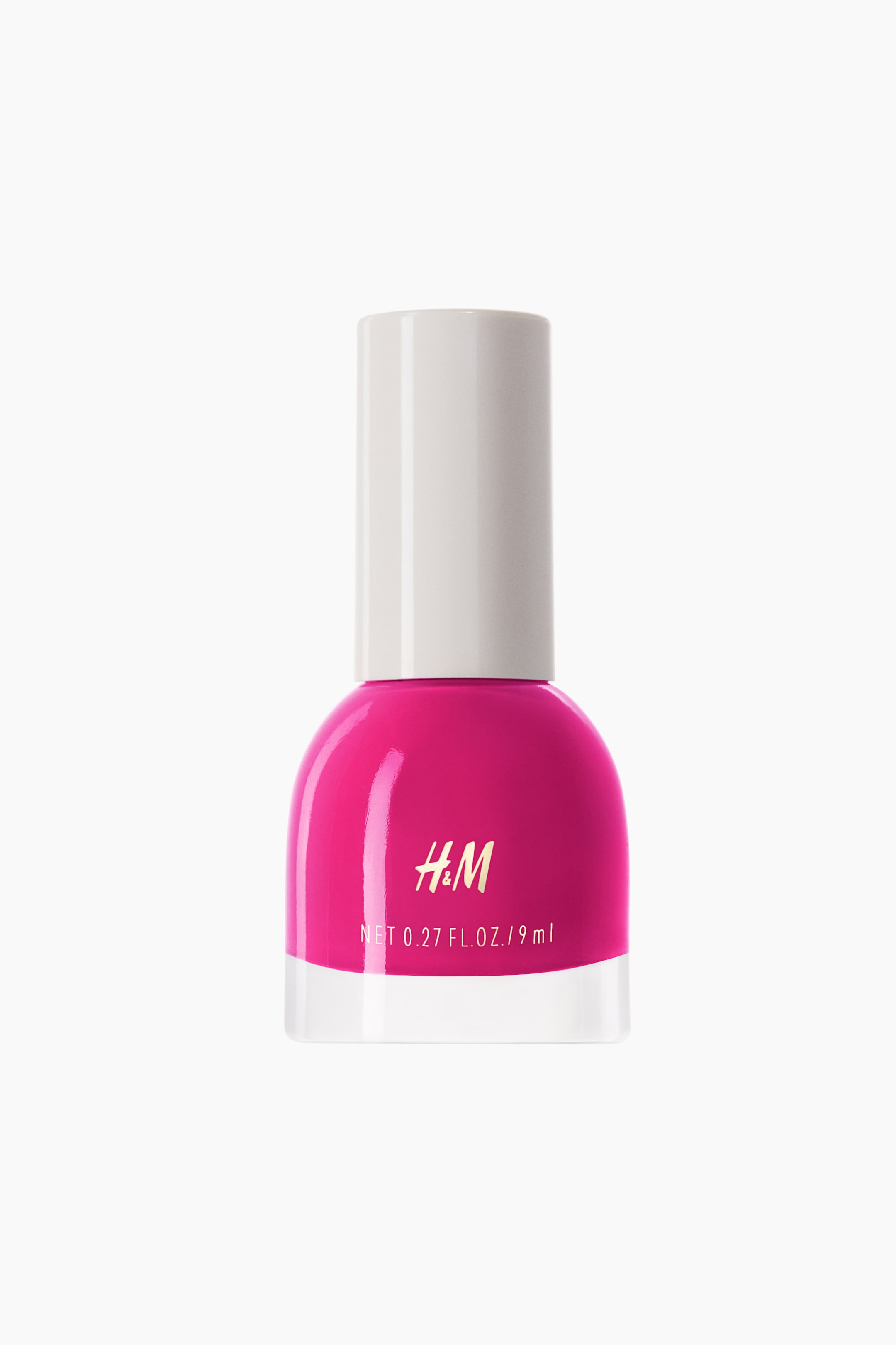 View larger image: The nail polish bottle showcases a vibrant pink liquid, adorned with a white cylindrical cap and a transparent glass base. The H&M logo is elegantly printed in gold, while the net volume is displayed in white on the front of the bottle.